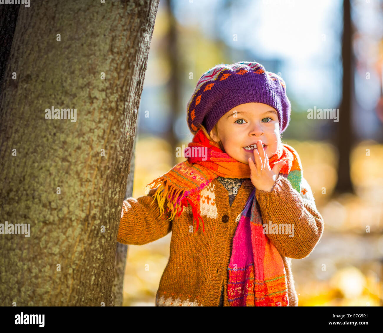 Happy little girl playing in the autumn park Stock Photo - Alamy