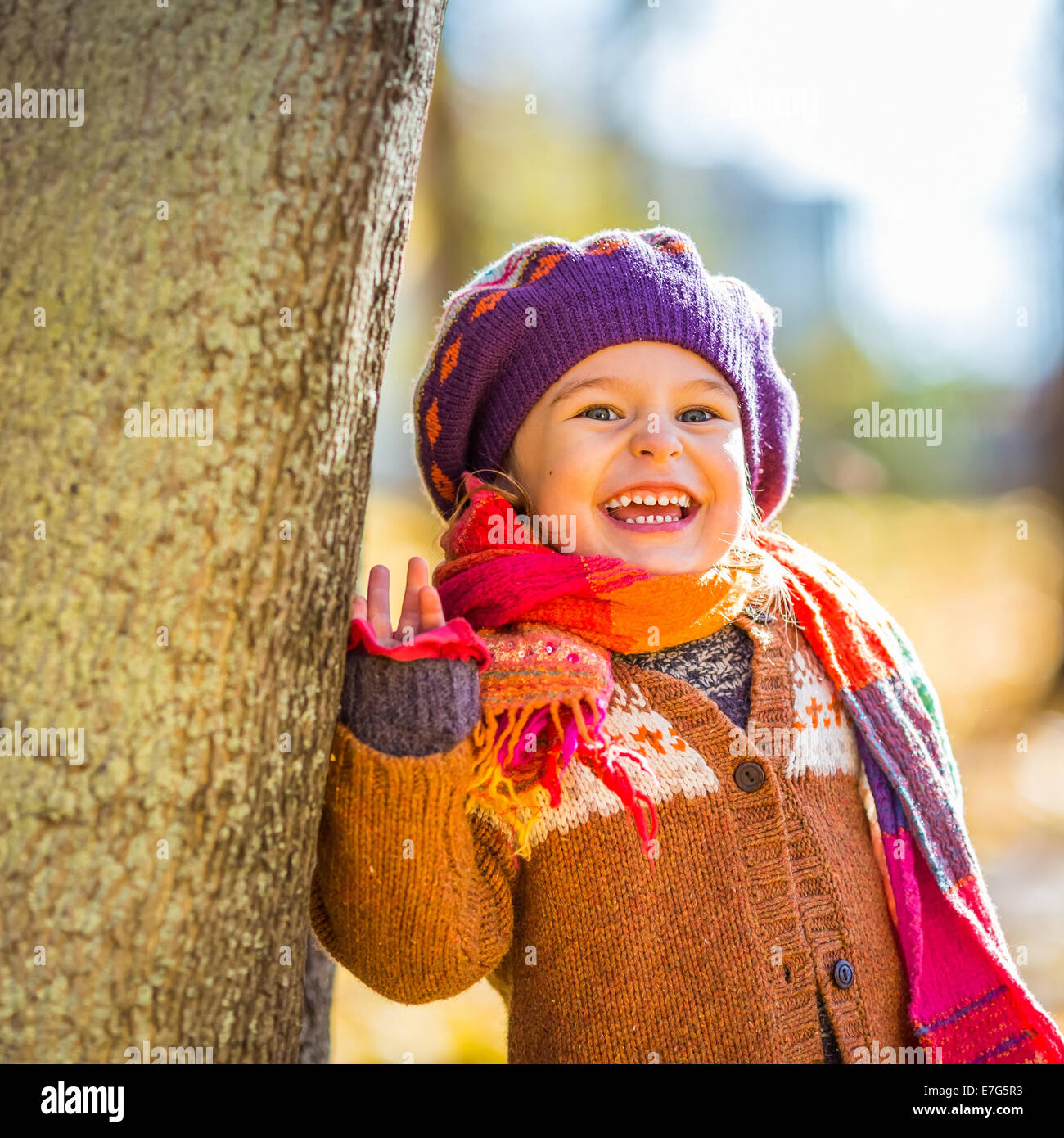 Happy little girl playing in the autumn park Stock Photo - Alamy