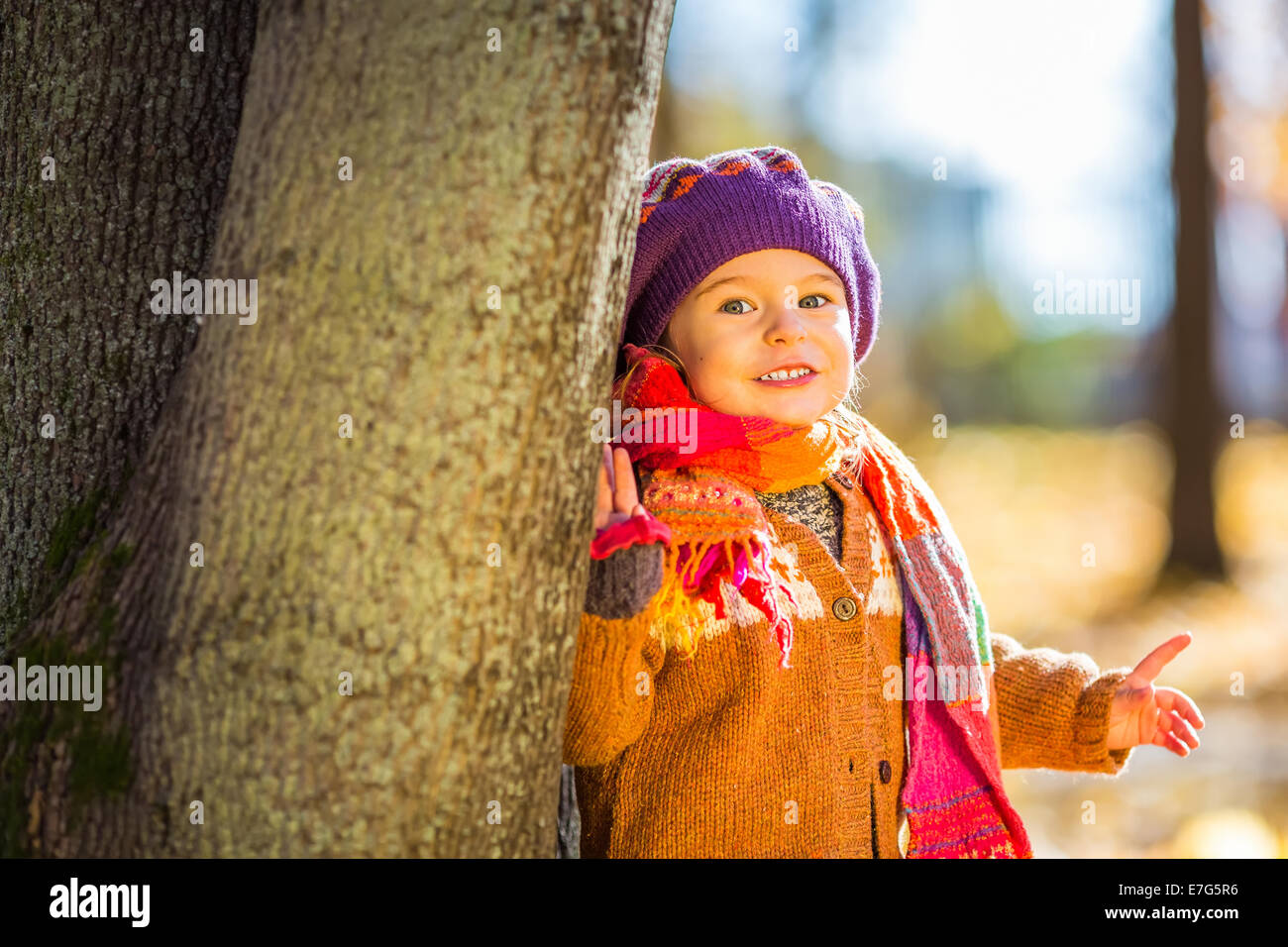 Happy little girl playing in the autumn park Stock Photo - Alamy