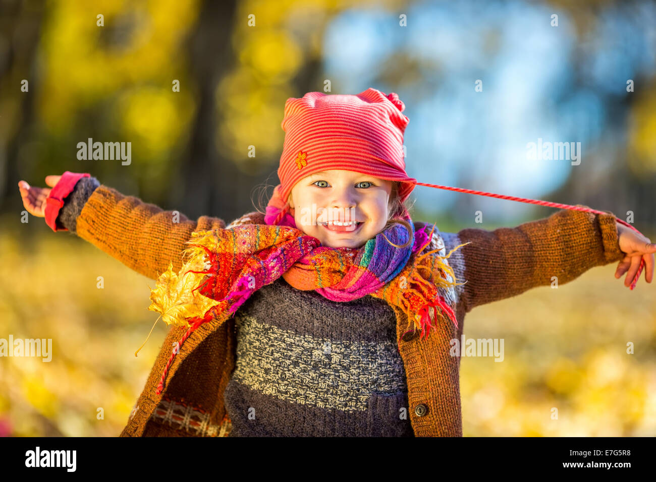 Happy little girl playing in the autumn park Stock Photo - Alamy