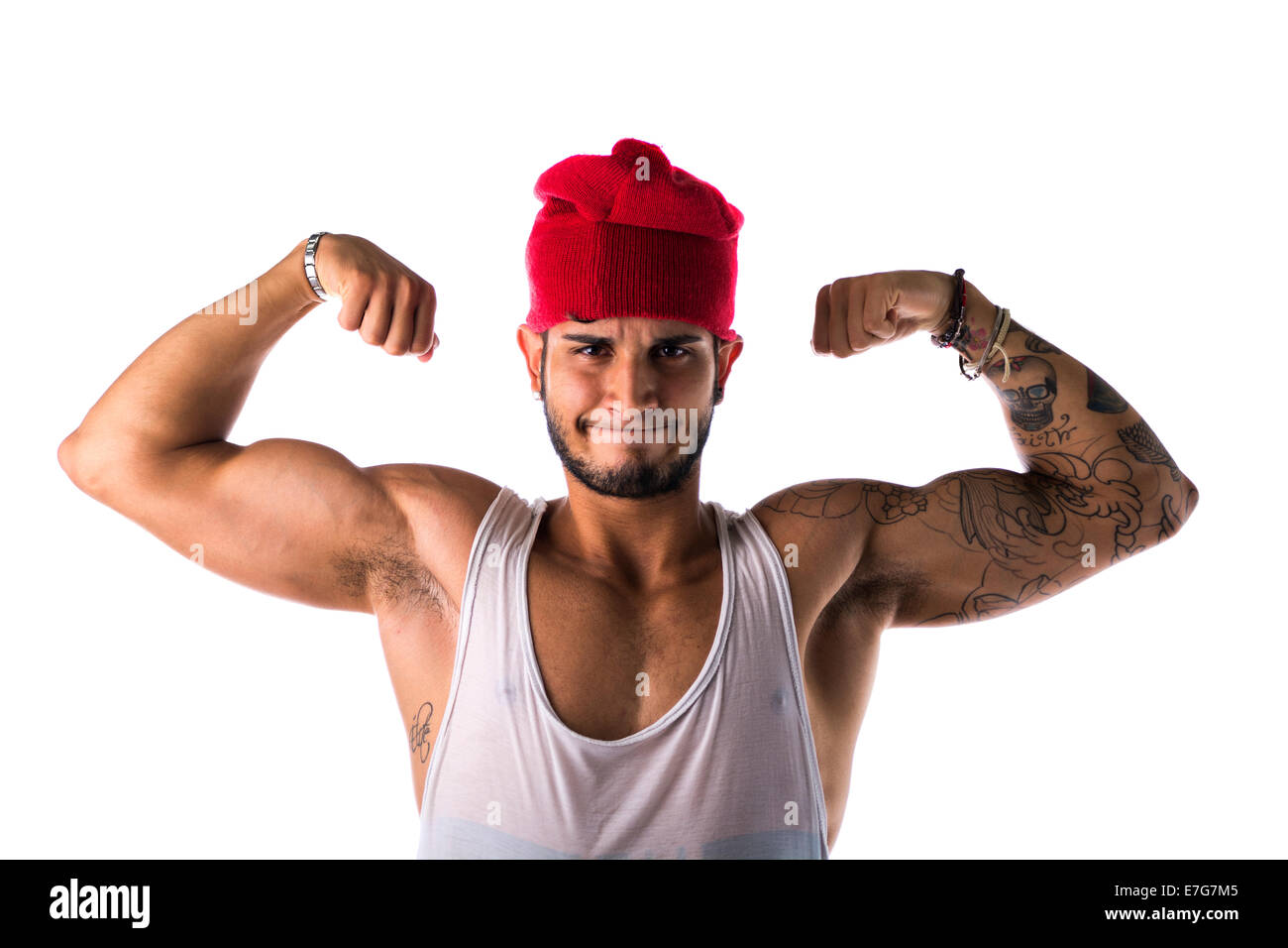 Portrait of handsome young man in funny red hat doing silly expression flexing biceps,  isolated on white Stock Photo
