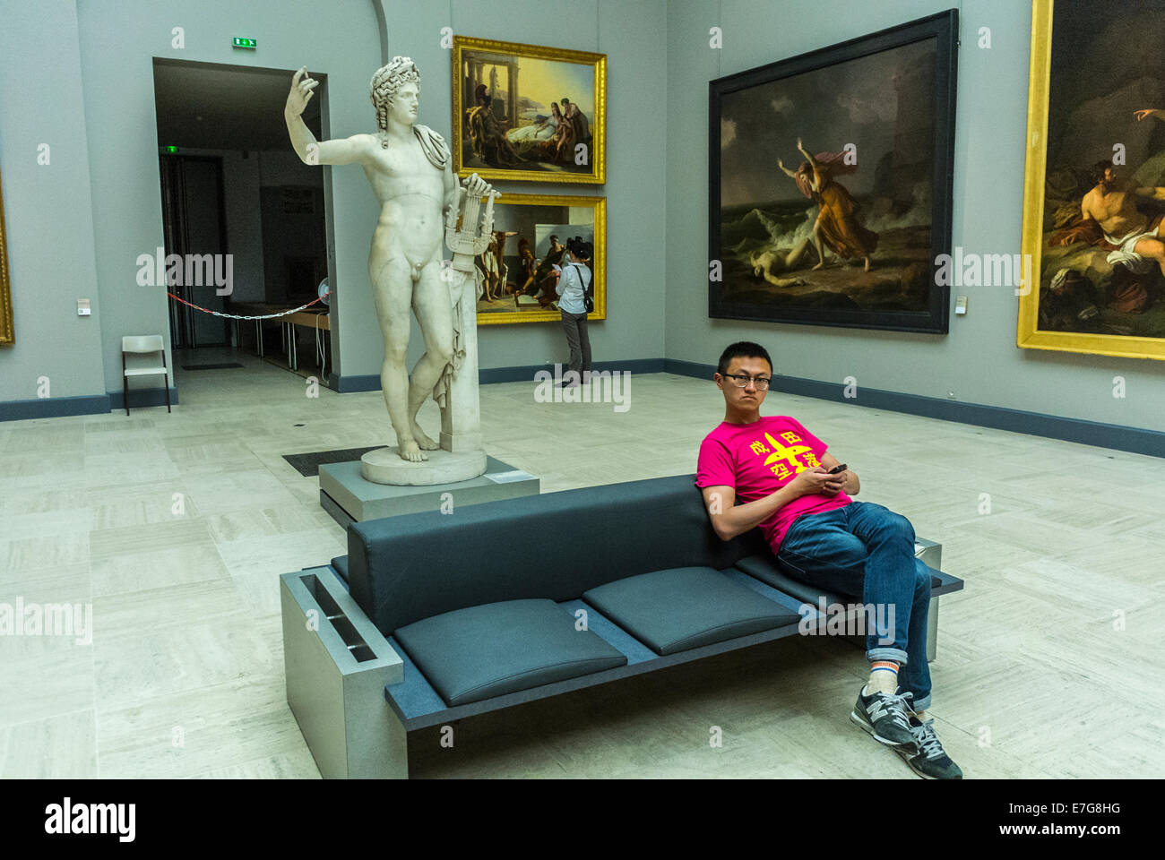 Bordeaux, France, Europe Chinese Tourist, Young Man Sitting resting, Visiting inside French Museum, 'Musée des Beaux-Arts' Stock Photo