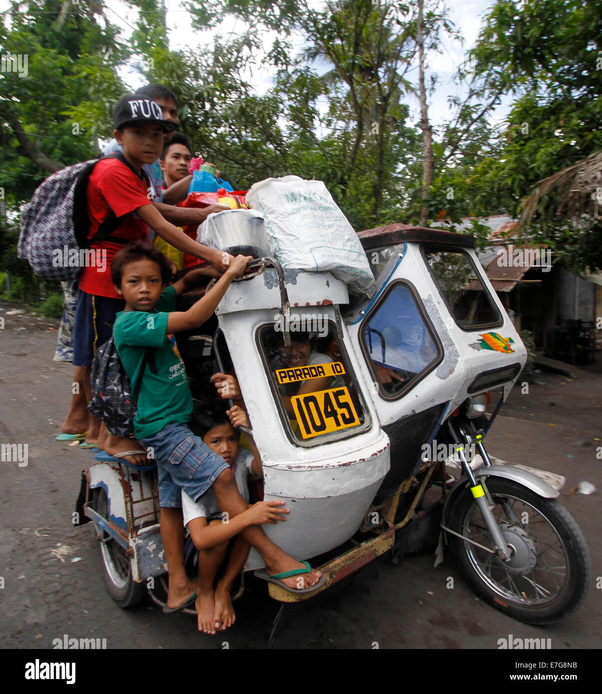 Albay, Philippines. 17th Sep, 2014. Residents crowd on a tricycle as they evacuate from the danger zone near the Mayon Volcano in Albay Province, the Philippines, Sept. 17, 2014. The Philippine Institute of Volcanology and Seismology (PHIVOLCS) said Wednesday that Mayon Volcano in the eastern Philippine province of Albay has exhibited 'intense activity' based on its 24-hour observation. Credit:  Stringer/Xinhua/Alamy Live News Stock Photo