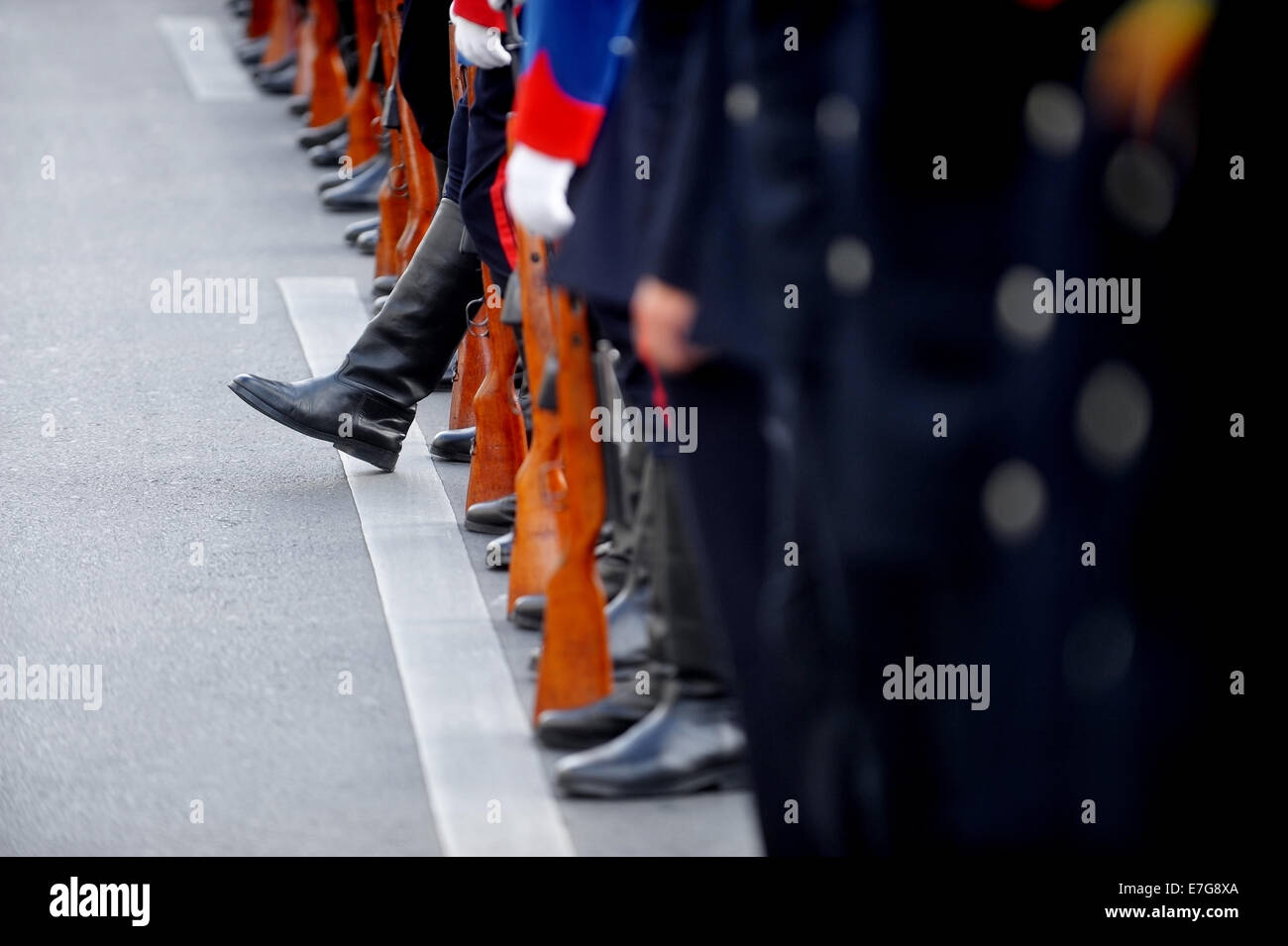 A soldier boot stands out from the line of rifle rest position during a military parade Stock Photo