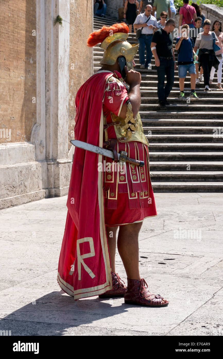 Italy: Roman legionary with smartphone at Spanish Steps in Rome . Photo from 5th September 2014. Stock Photo