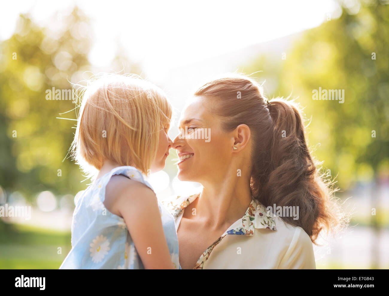 Portrait of happy mother and baby girl outdoors Stock Photo