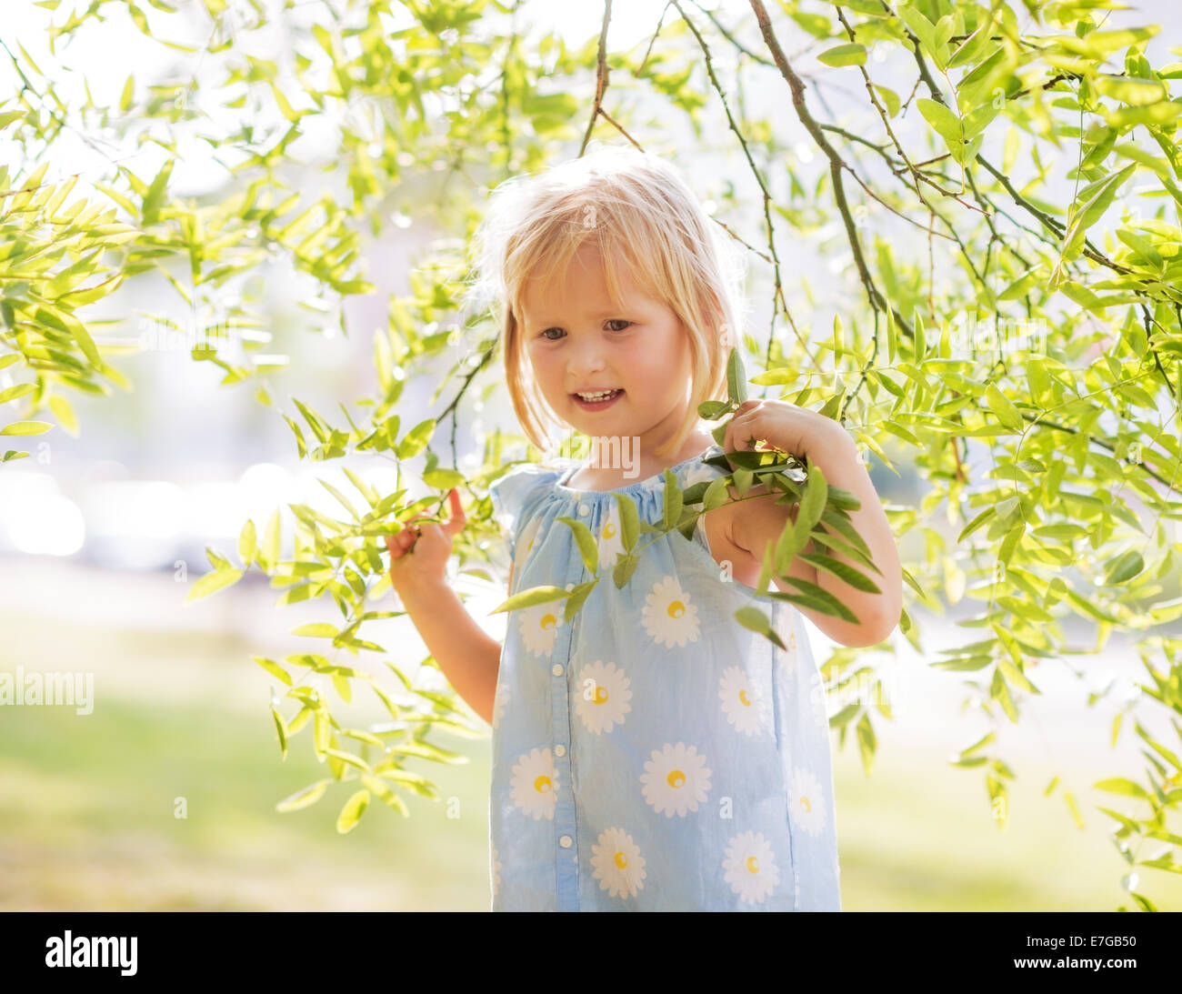 Portrait of happy baby girl in foliage Stock Photo