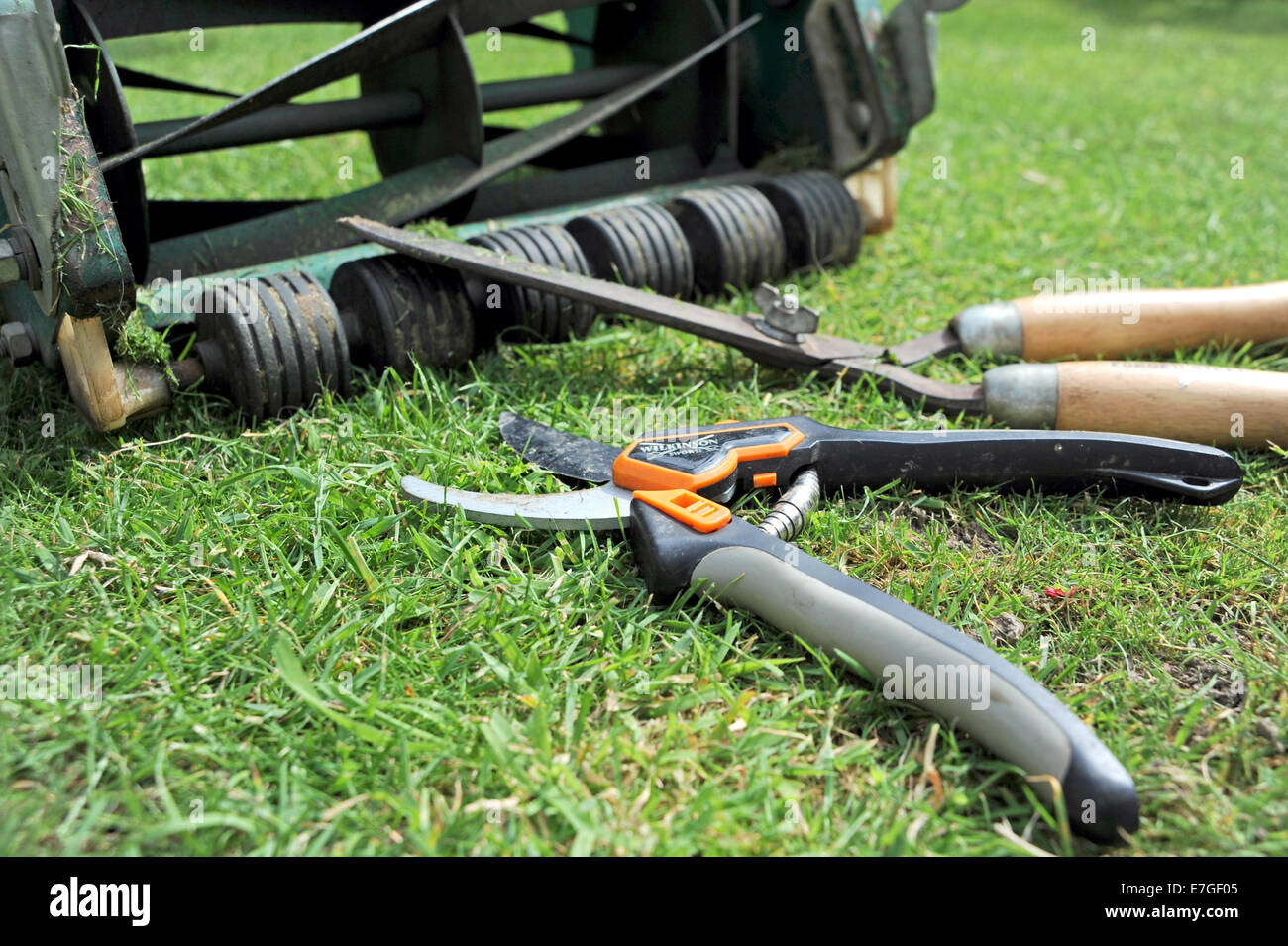 Garden pruning shears manual lawnmower and hand hedge trimmers Stock Photo