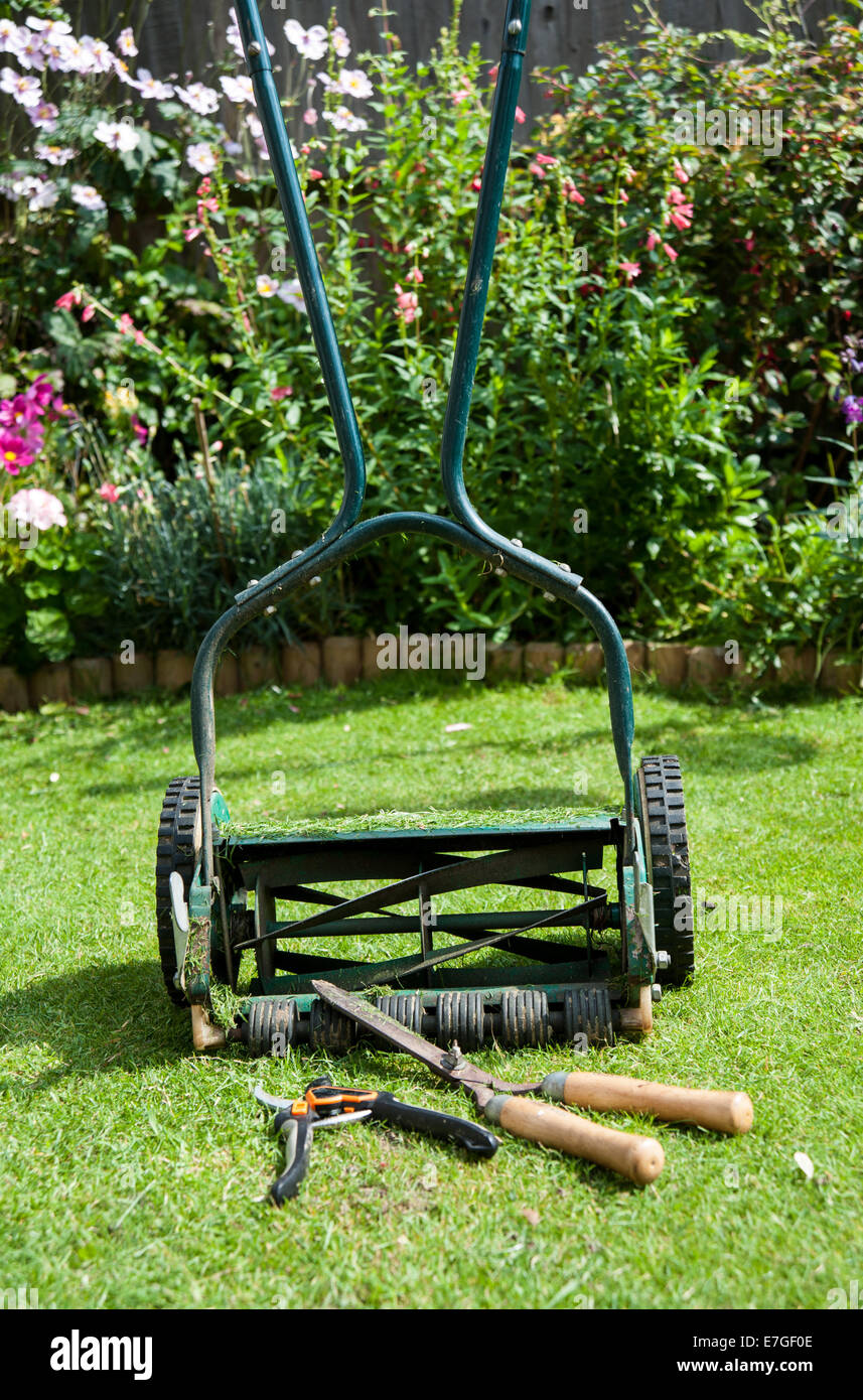 Garden pruning shears manual lawnmower and hand hedge trimmers Stock Photo