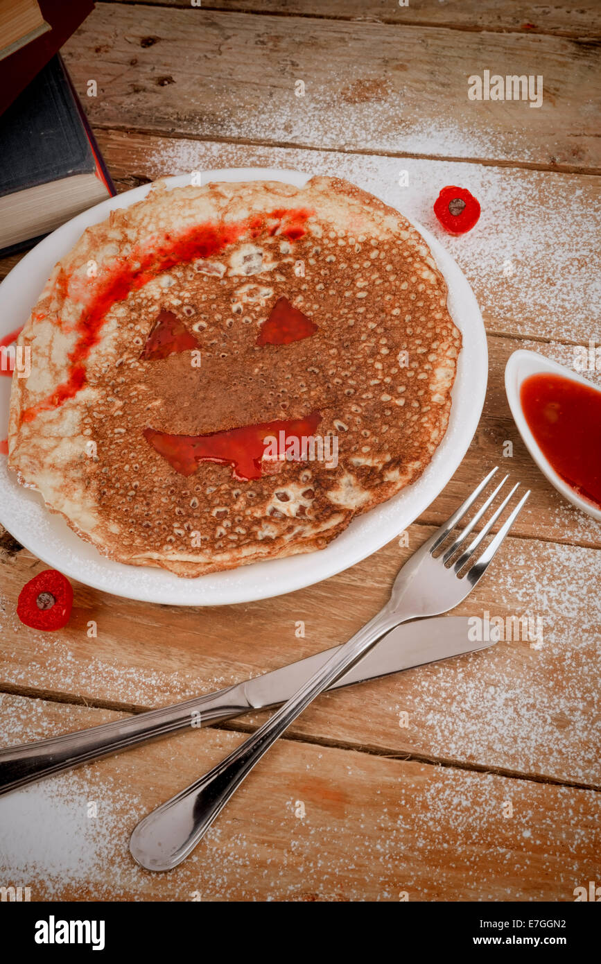 Pancake face with red sauce, a funny Halloween dessert Stock Photo Alamy