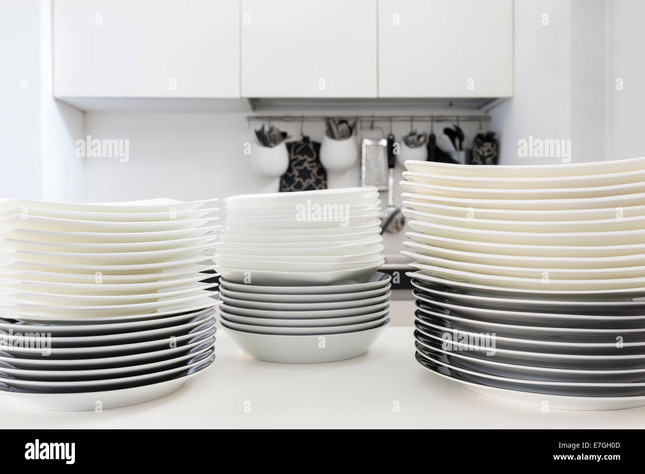 stacks of clean dishes on the kitchen table Stock Photo