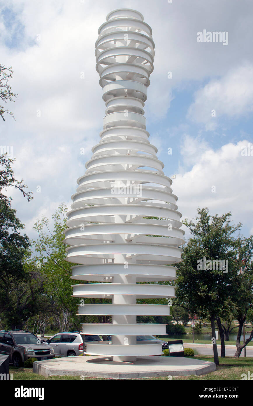 A sleek modern bowling pin sculpture in Dallas, TX, blends playful sports imagery with contemporary public art design. Stock Photo