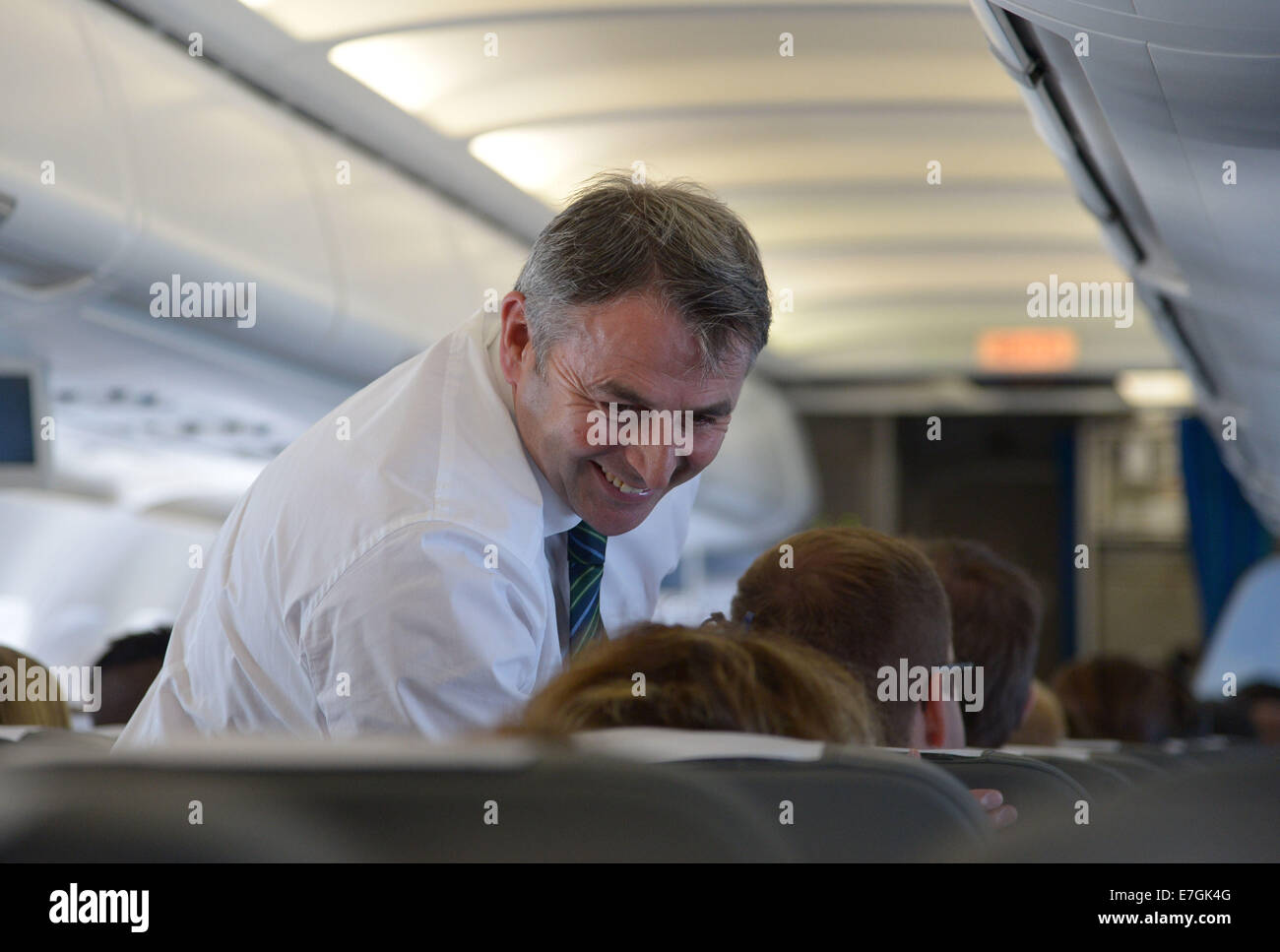 Wolfsburg's manager Klaus Allofs in the airplane to Liverpool, Britain, 17 September 2014. The VfL Wolfsburg plays against the FC Everton in Liverpool on 18 September 2014. Photo: Peter Steffen/dpa Stock Photo