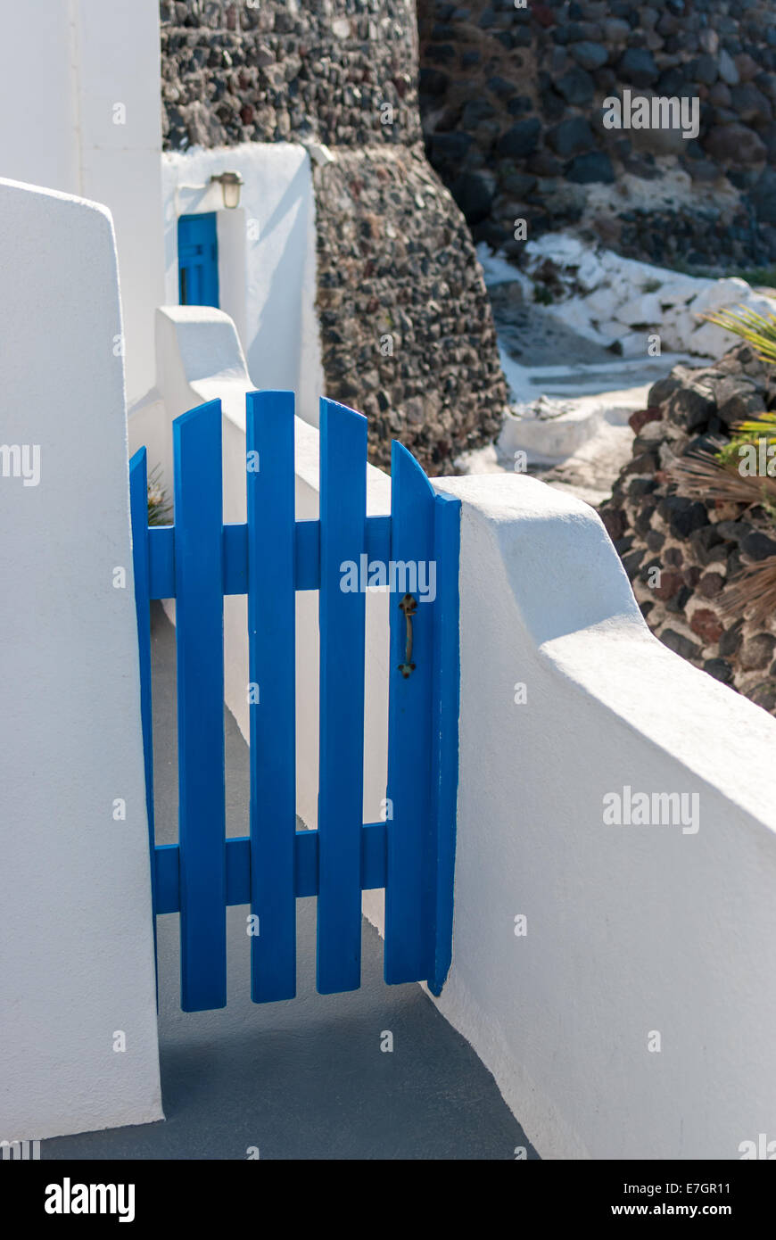 Blue door on the balcony of a white greek house in Santorini Stock Photo