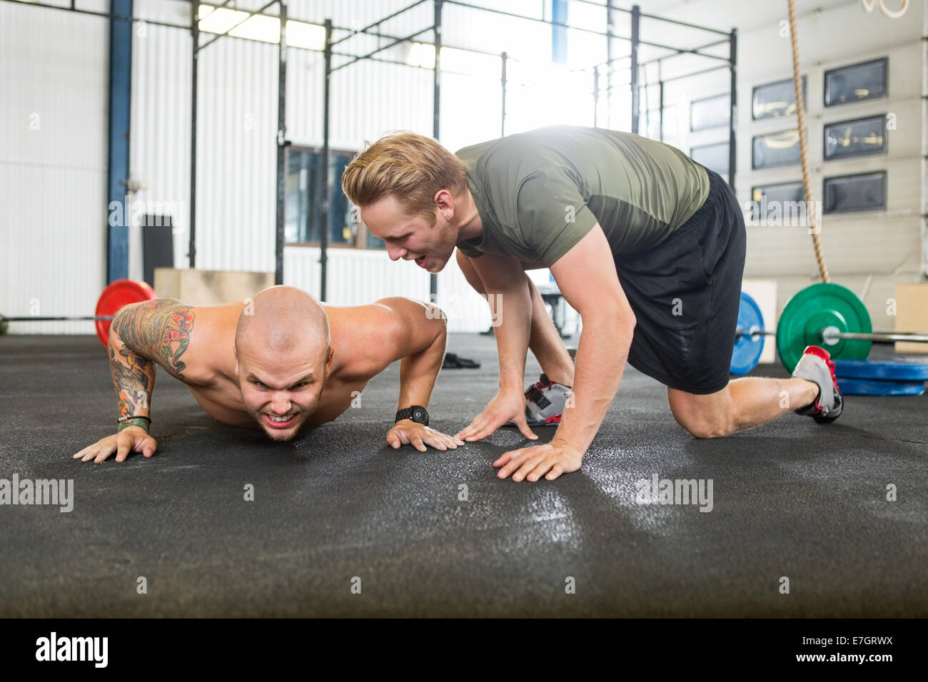 Trainer Motivating Man In Doing Pushups Stock Photo - Alamy