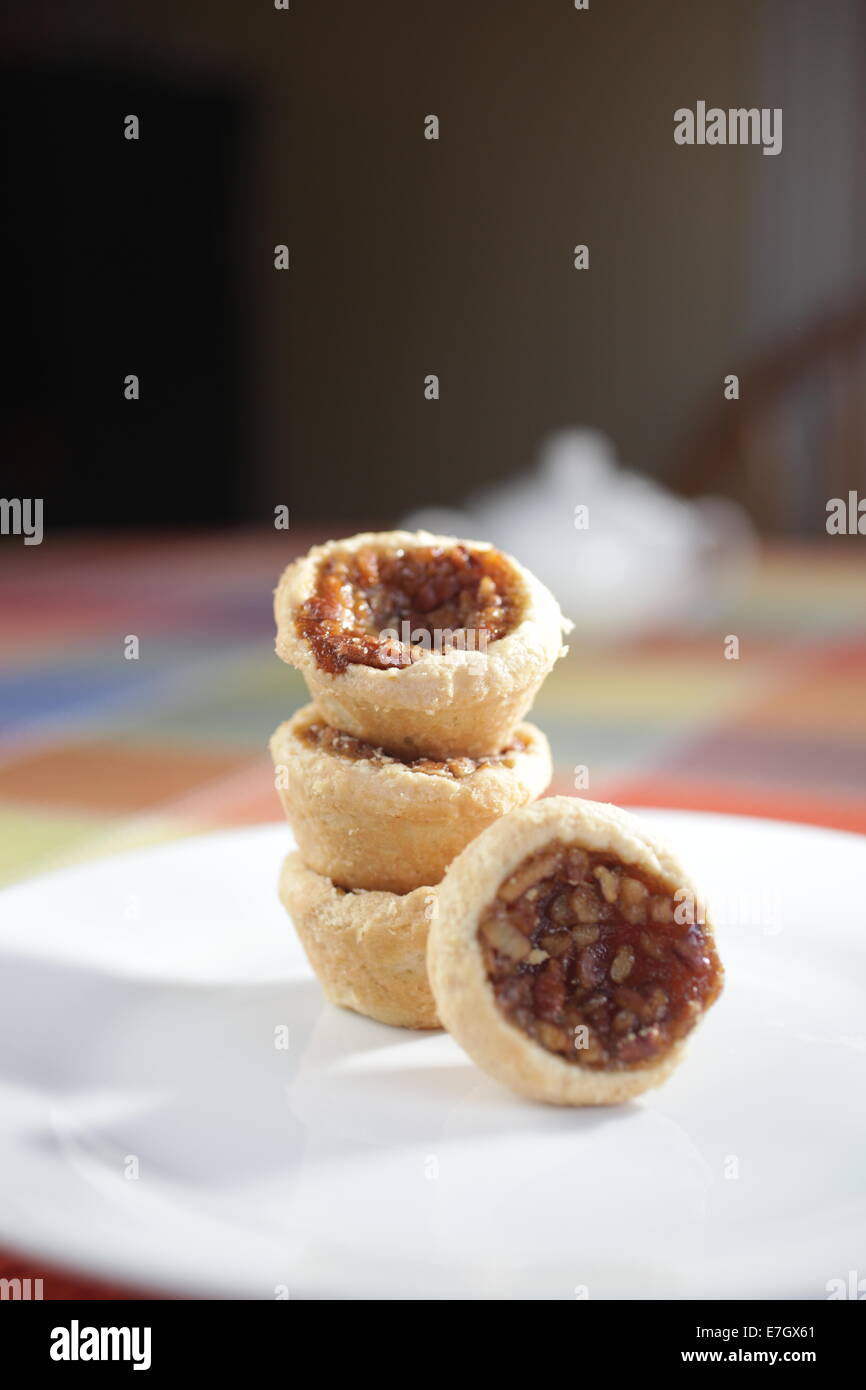 mini pecan tarts on a white plate Stock Photo