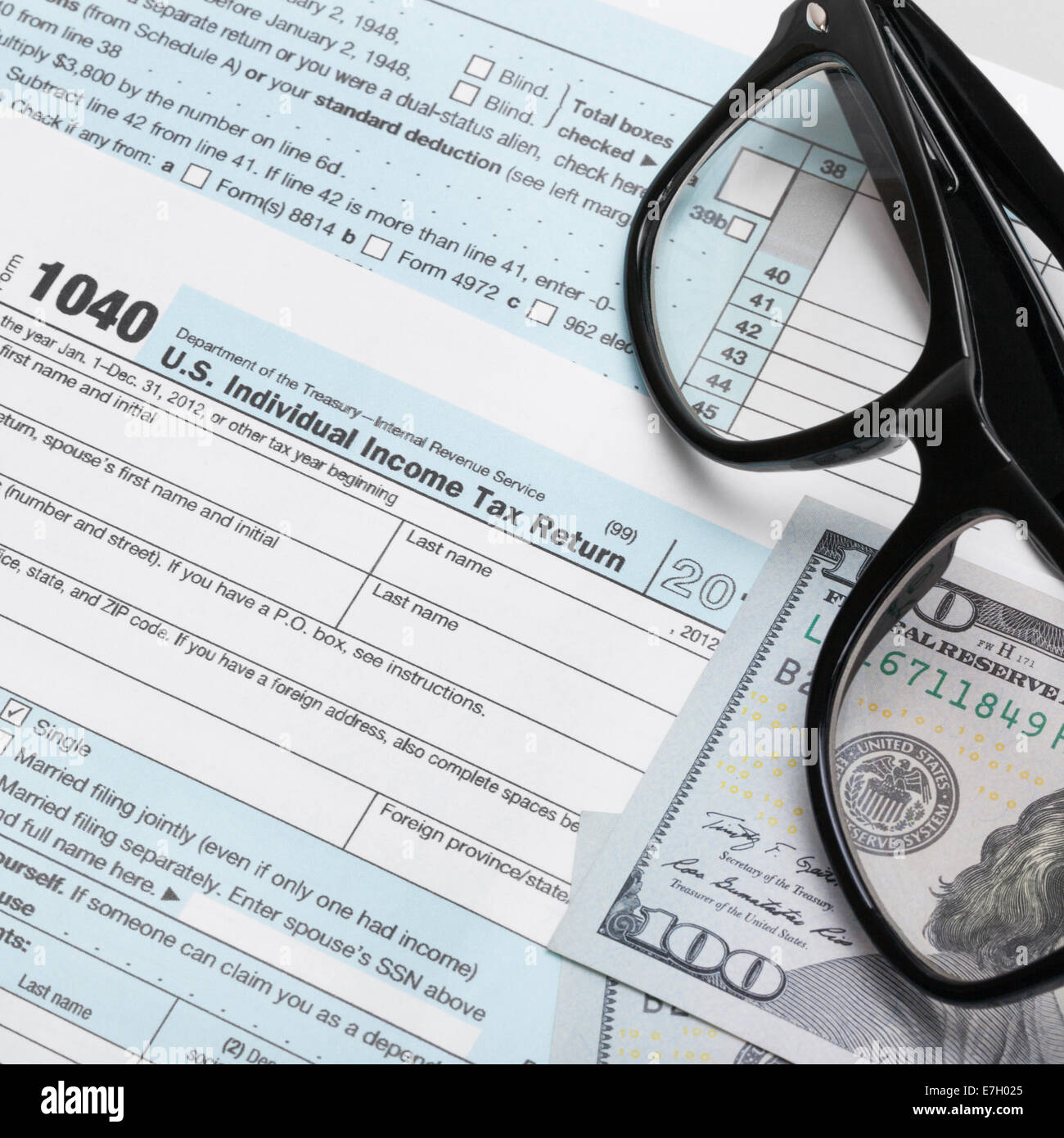 USA Tax Form 1040 with glasses and 100 US dollar bills - 1 to 1 ratio ...