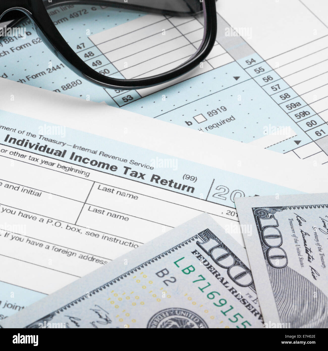 USA Tax Form 1040 with glasses and 100 US dollar bills - 1 to 1 ratio ...