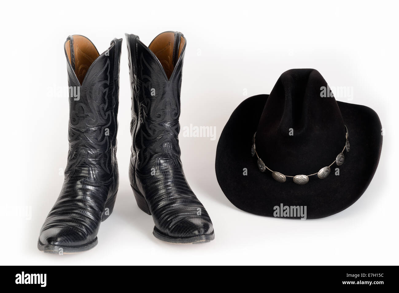 Black Cowboy Boots and Hat with Concho Hatband. Stock Photo
