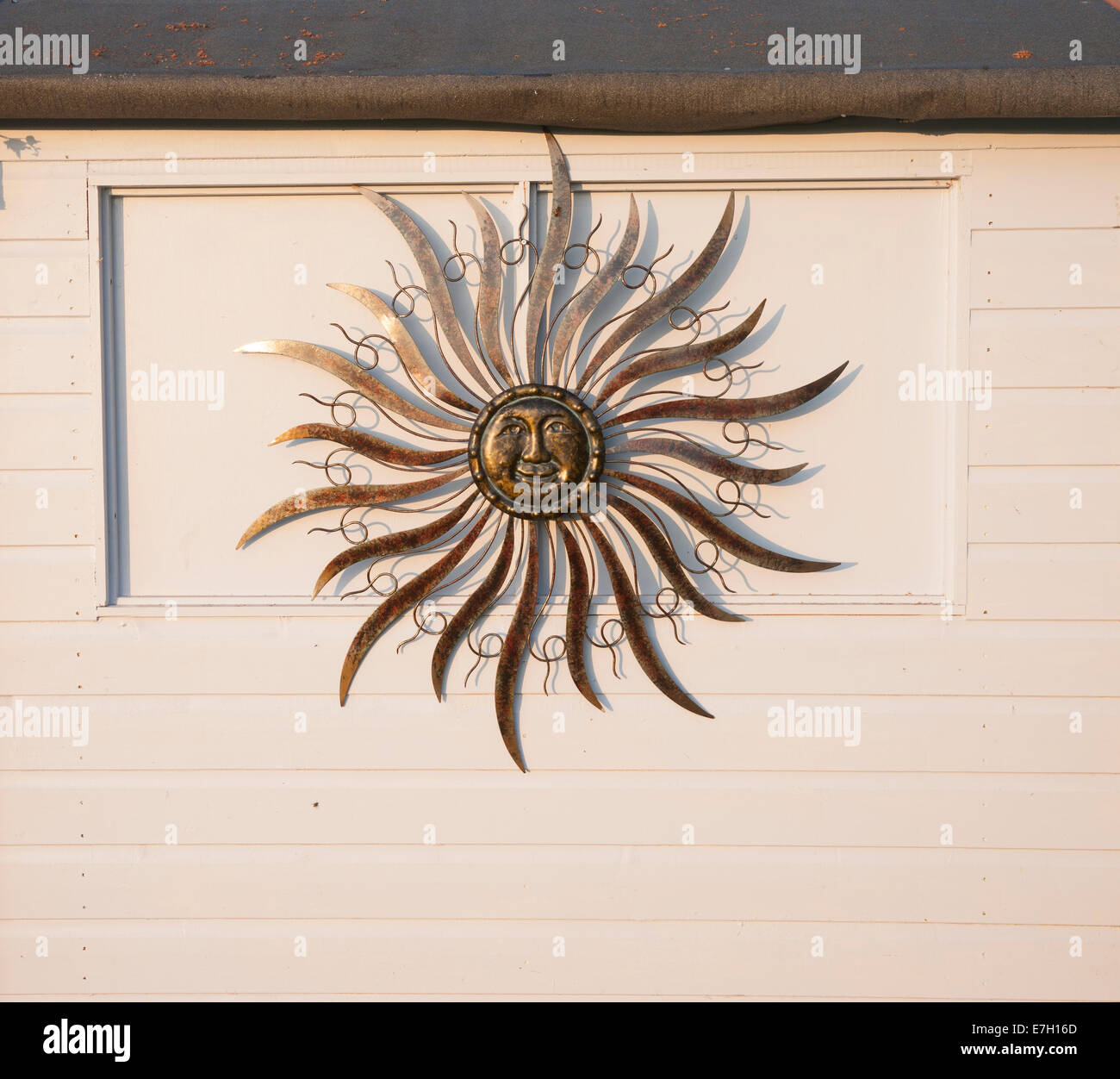Sun wall decoration on garden shed Stock Photo