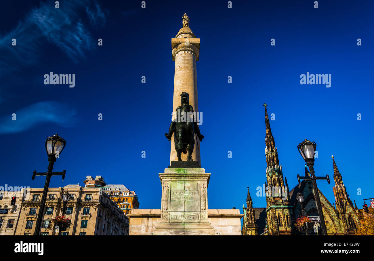 Statue and the Washington Monument in Mount Vernon, Baltimore, Maryland. Stock Photo