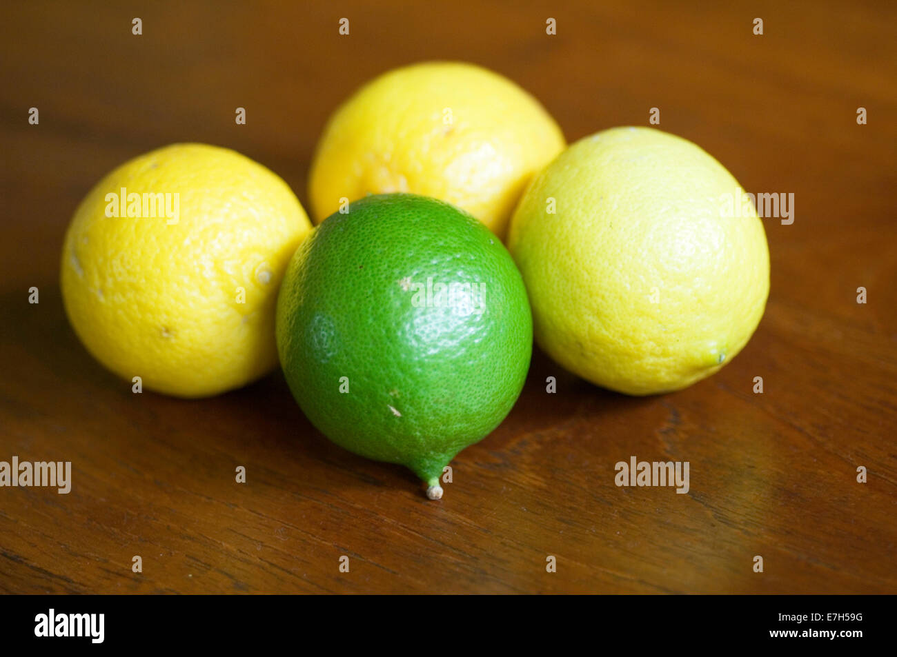 Green and yellow Tahitian limes on a wood surface Stock Photo - Alamy