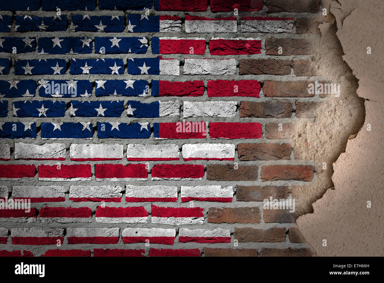 Dark brick wall texture with plaster flag painted on wall USA Stock