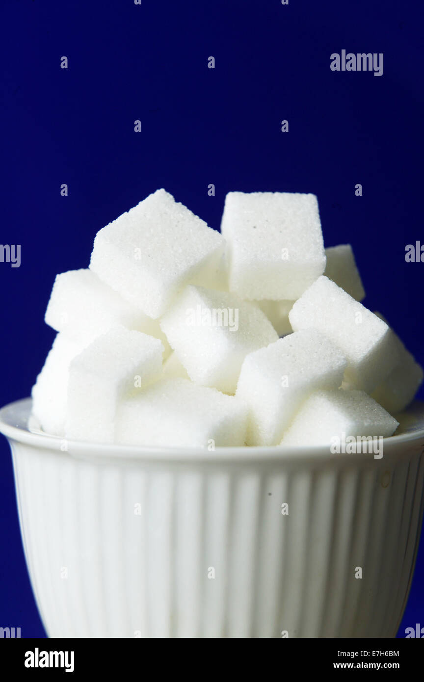 White sugar cubes in a bowl. Stock Photo
