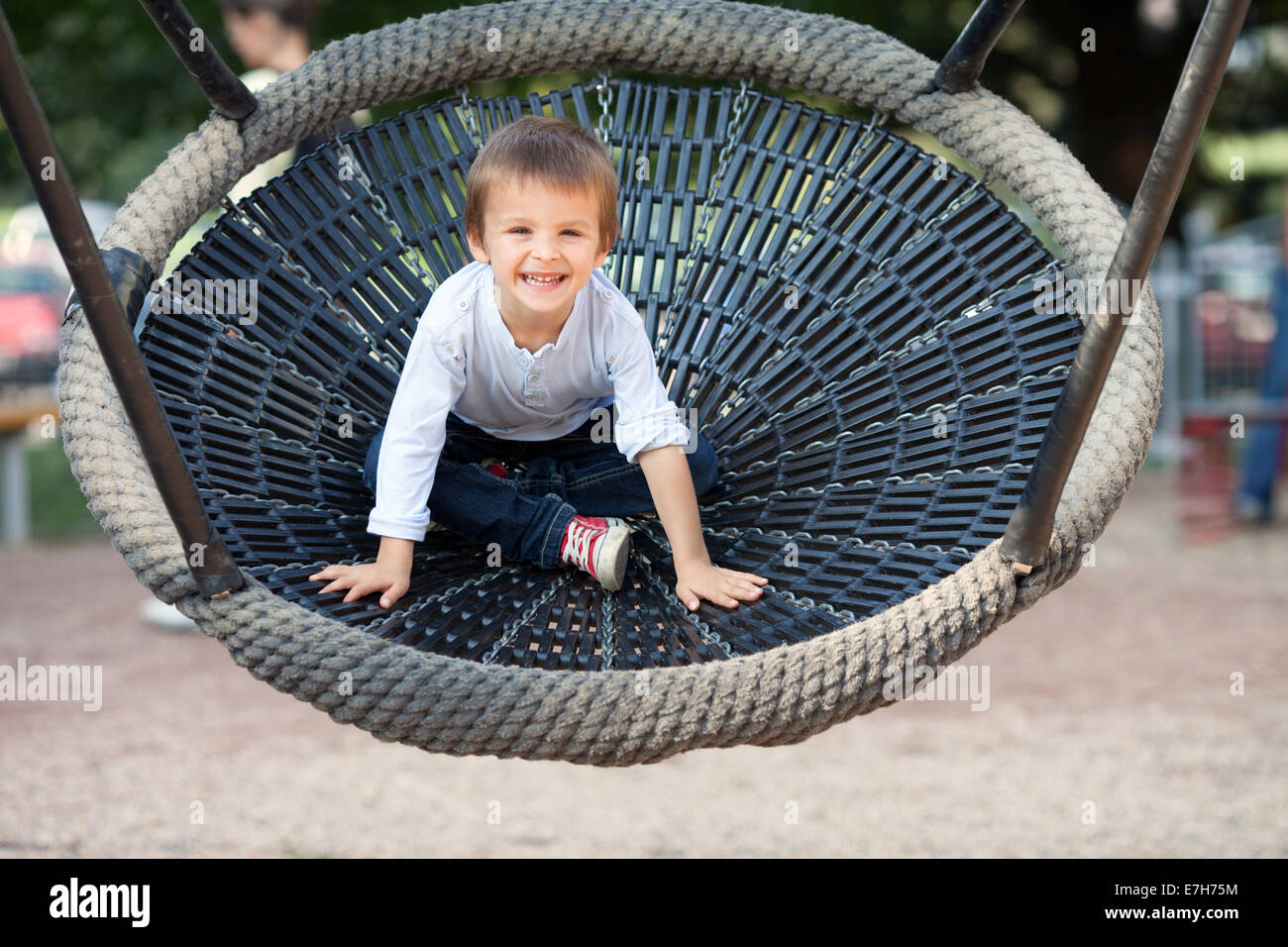 Smiling Toddler Boy on a Swing in the Park Stock Photo - Alamy