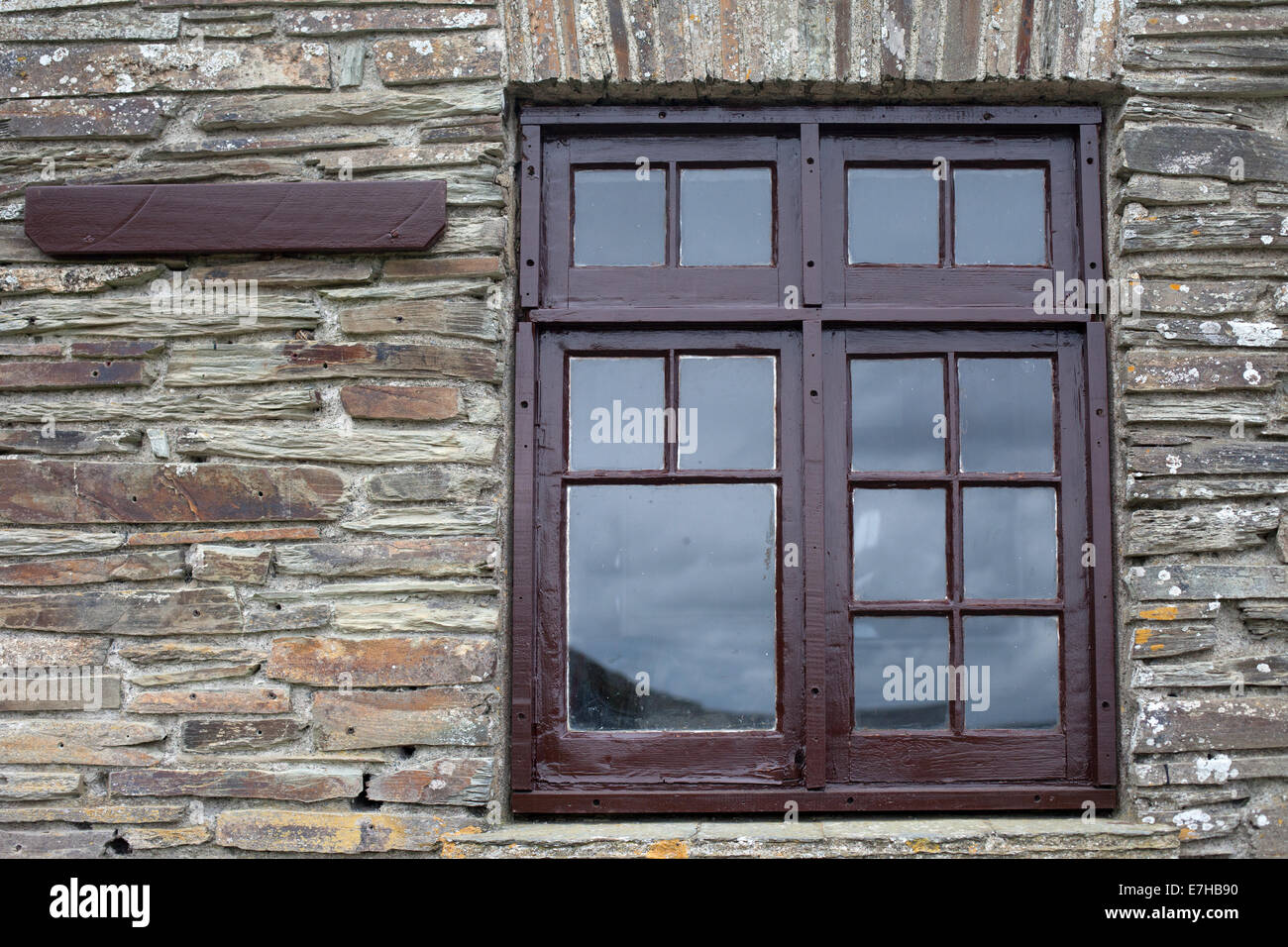 Brown window frame on a brick wall Stock Photo