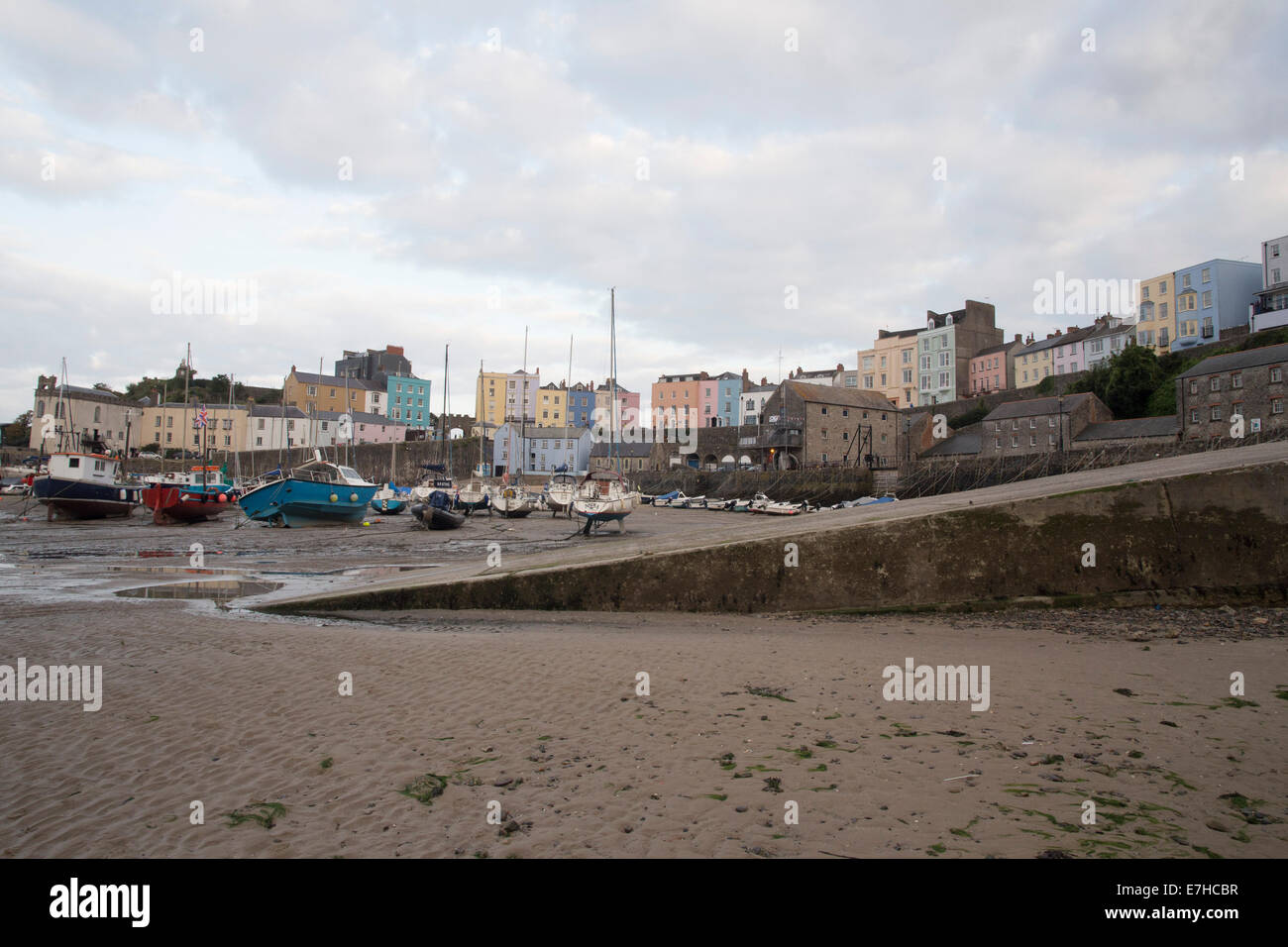 Tenby harbour at dusk. Low tide. Boats on sand. Stock Photo