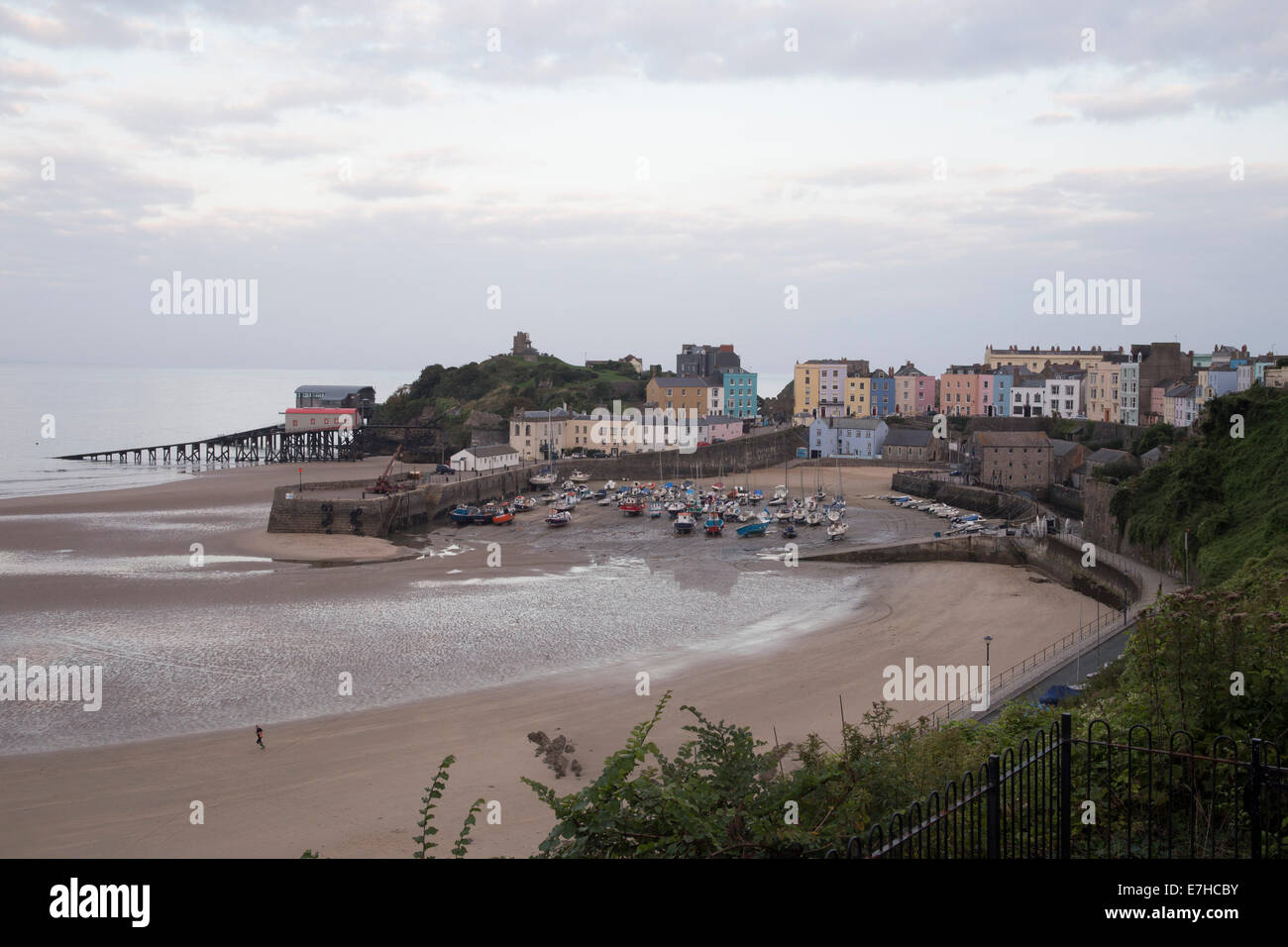 Tenby harbour at dusk. Low tide. Boats on sand. Stock Photo