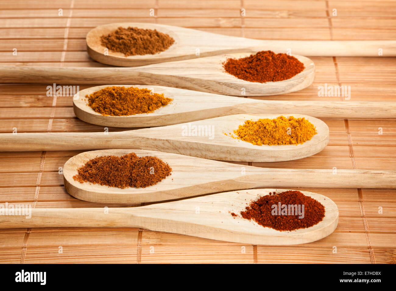 Assorted spices on wooden cooking spoons Stock Photo