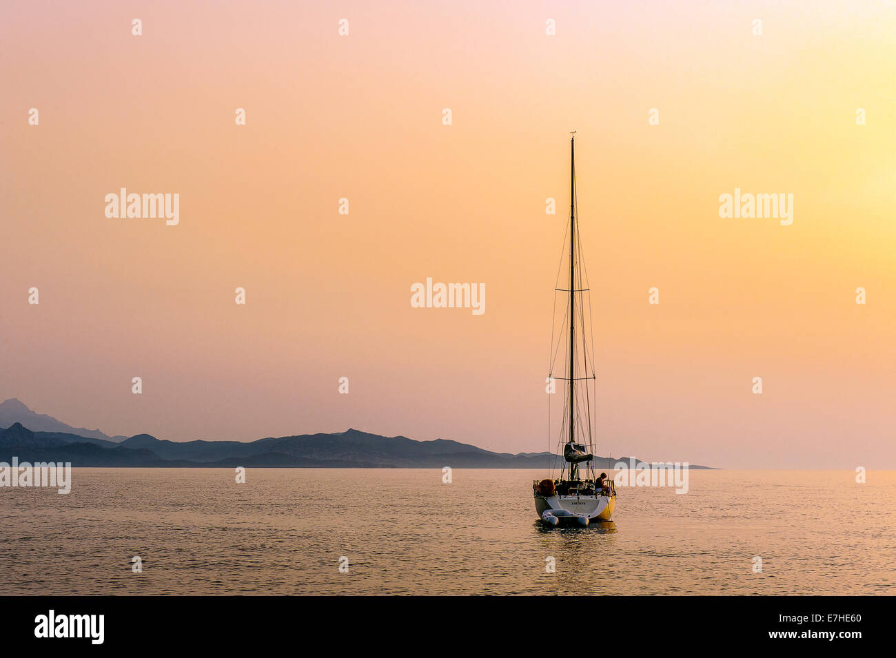 Europe, France, Corsica, Haute Corse, Cap Corse. Nonza. Anchored sailboat at dusk. Stock Photo