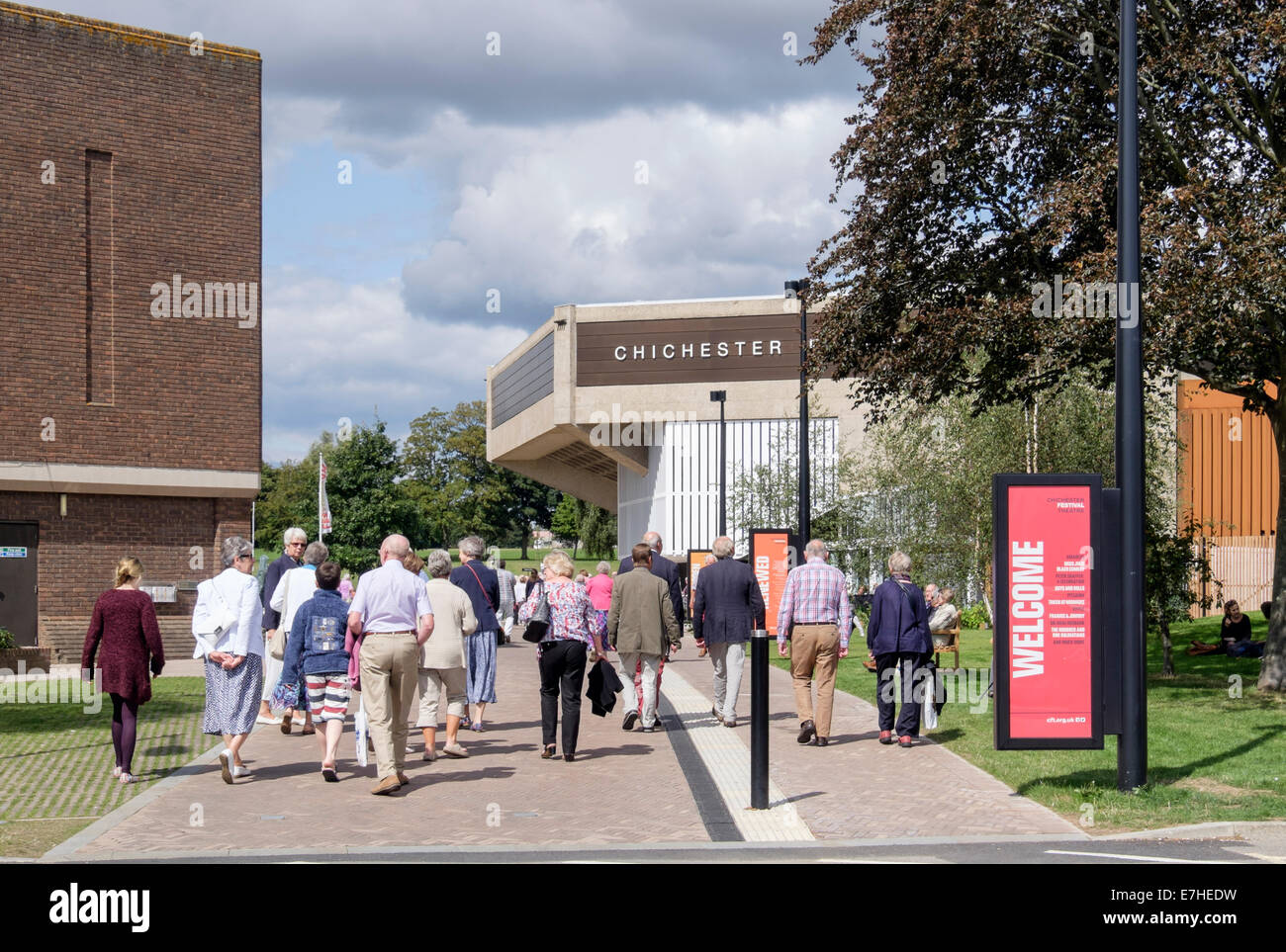 People arriving for a matinee performance at Chichester Festival Theatre in Oaklands Park. Chichester West Sussex England UK Stock Photo