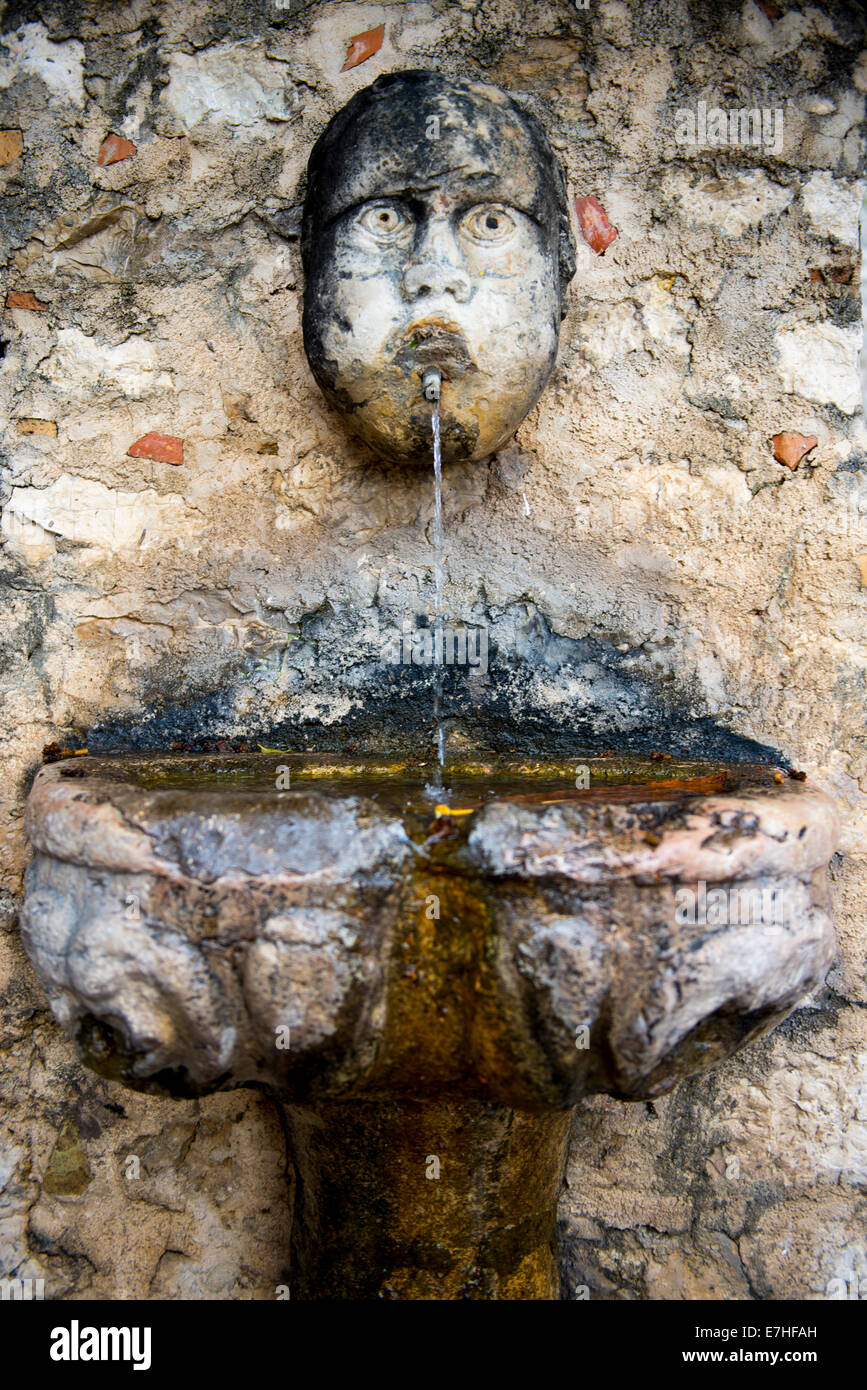 Water fountain with spout in the shape of a man's head Stock Photo Alamy