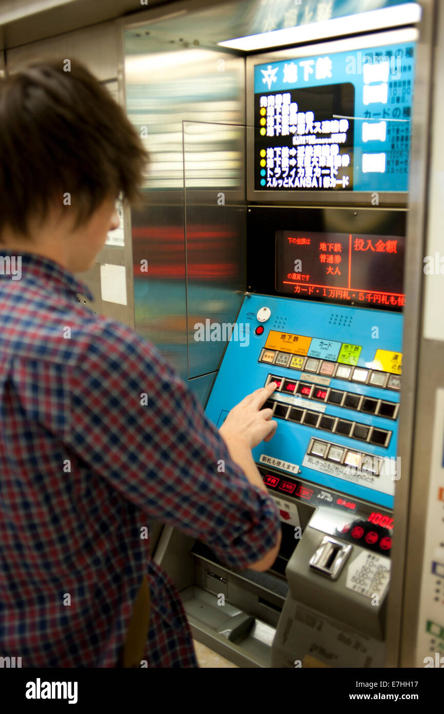 Using a metro ticket machine in Kyoto, Japan. Stock Photo