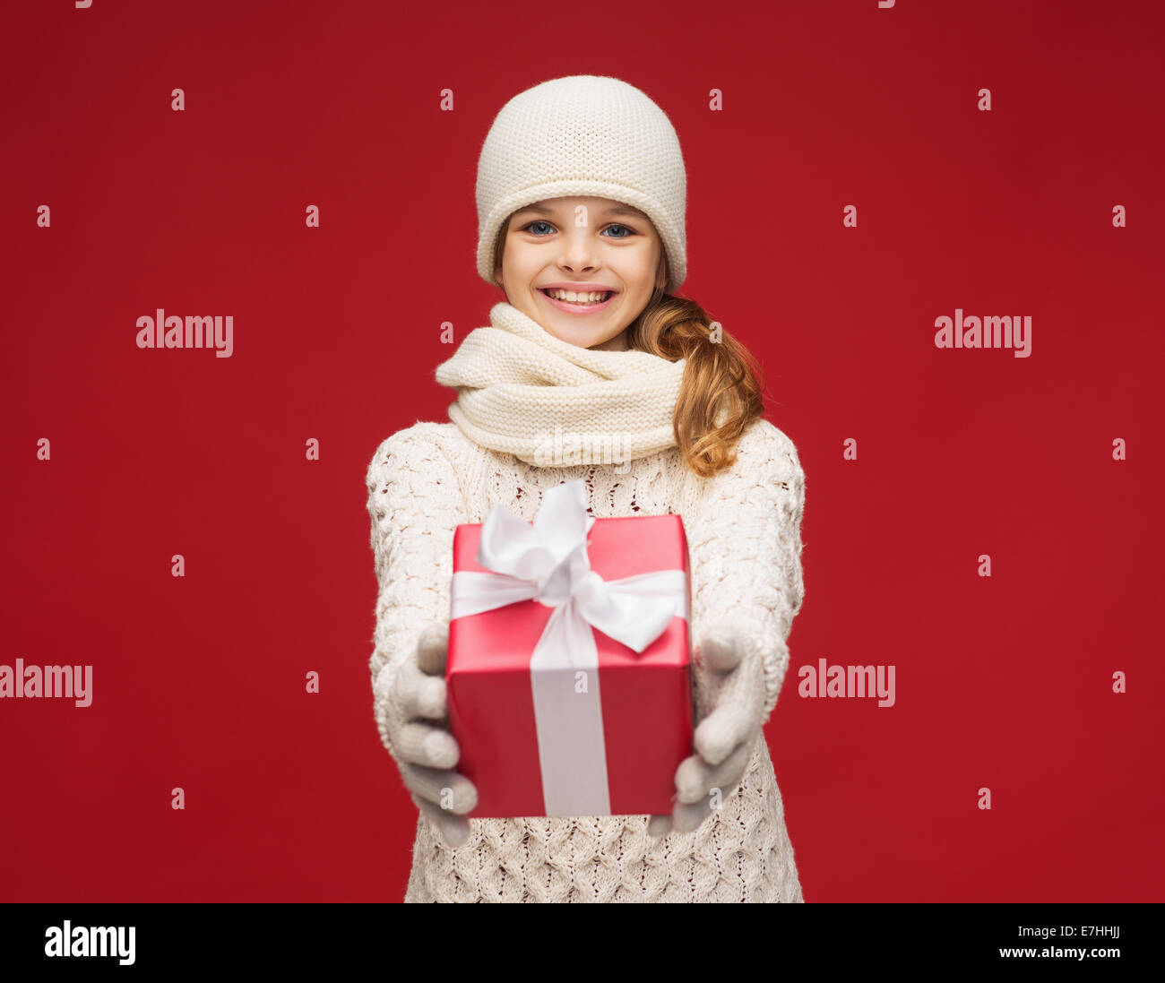 girl in hat, muffler and gloves with gift box Stock Photo