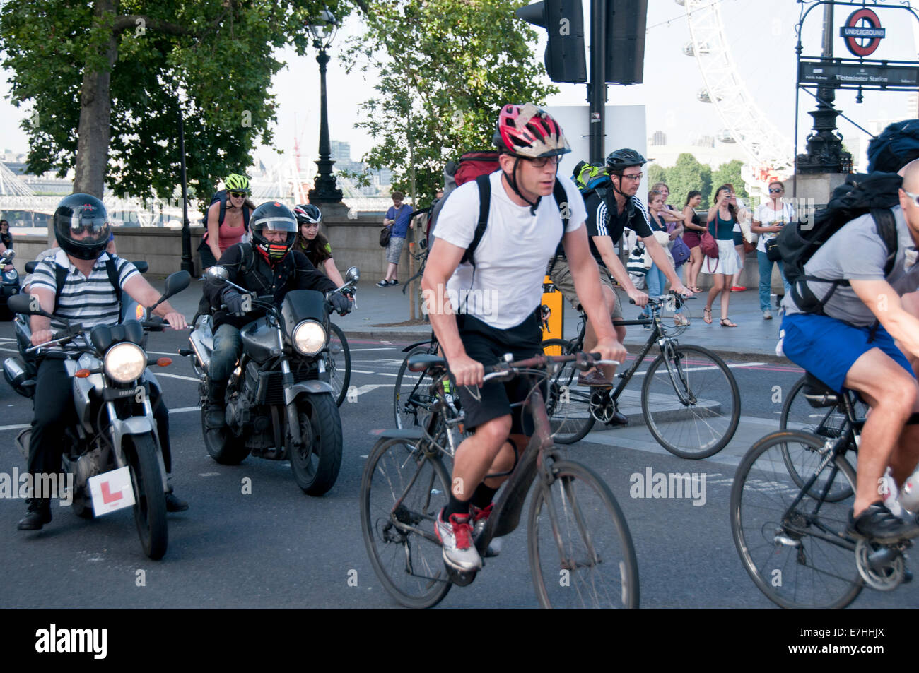 Motorbikes and bicycles taking off from traffic lights through traffic in London Stock Photo