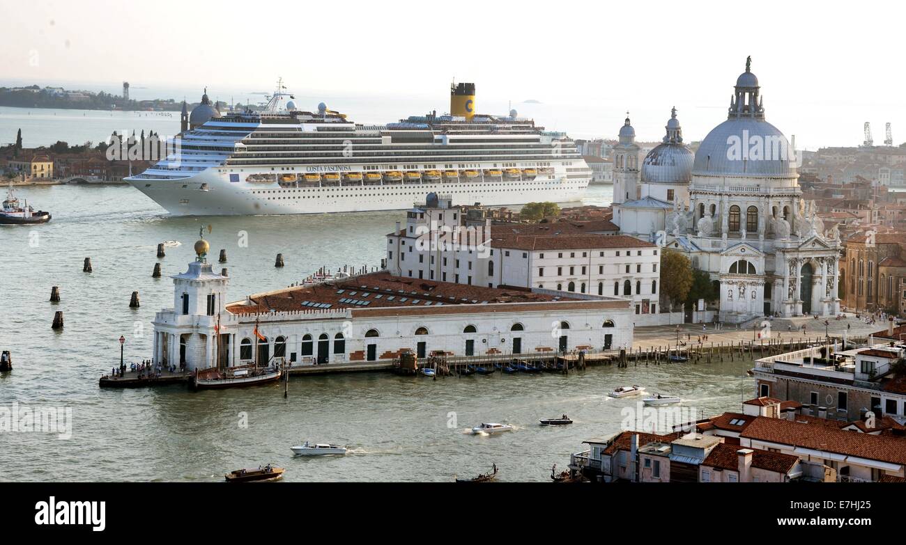 A Costa cruise ship leaves the harbour and passes close to Punta della Dogana with the church Santa Maria della Salute and the Piazza San Marco in Venice, Germany, 08 September 2014. A debate is currently going on about the passage of cruise ships this close to the city and the dangers for the environment this poses. The huge cruise ships are supposed to using the route close to Giudica in the future but rater the one closer to the train station, which is further from the city. Channels would have to be deepened and widened for this solution, however. Photo: Waltraud Grubitzsch -NO WIRE SERVIC Stock Photo
