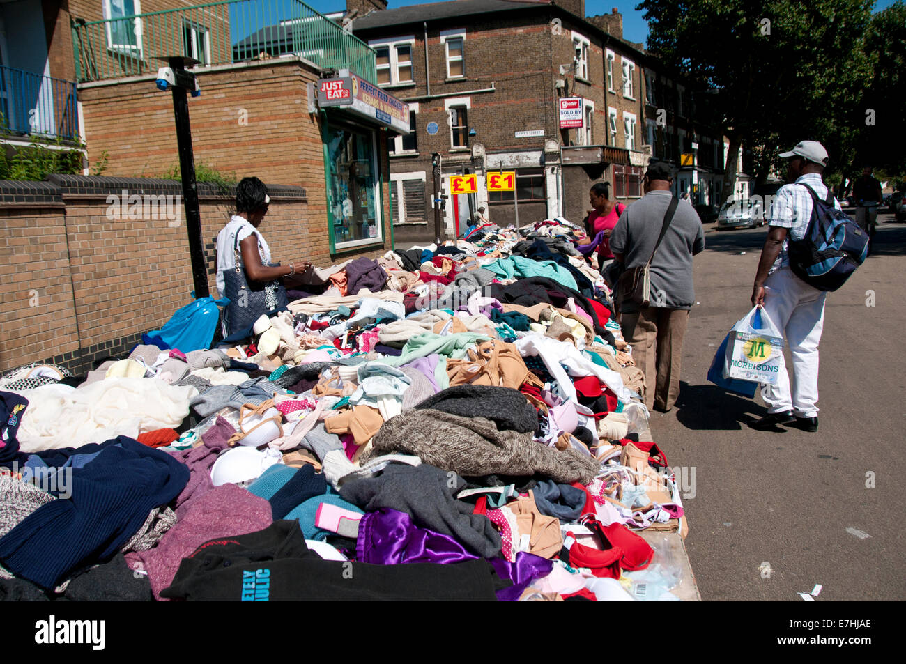 Second hand clothes stall in East Lane market South London Stock Photo