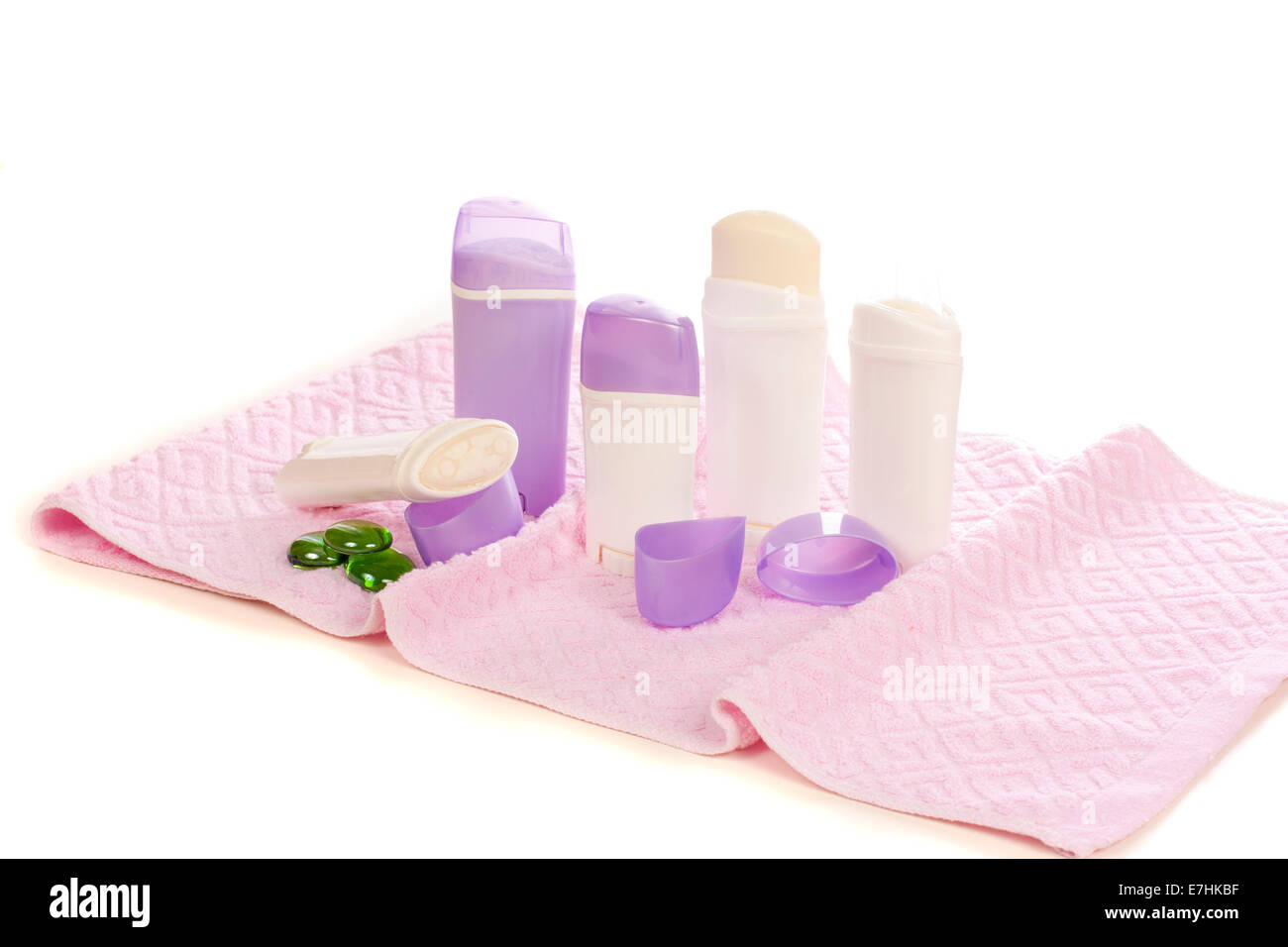 Deodorants placed on the towel isolated over white background Stock Photo