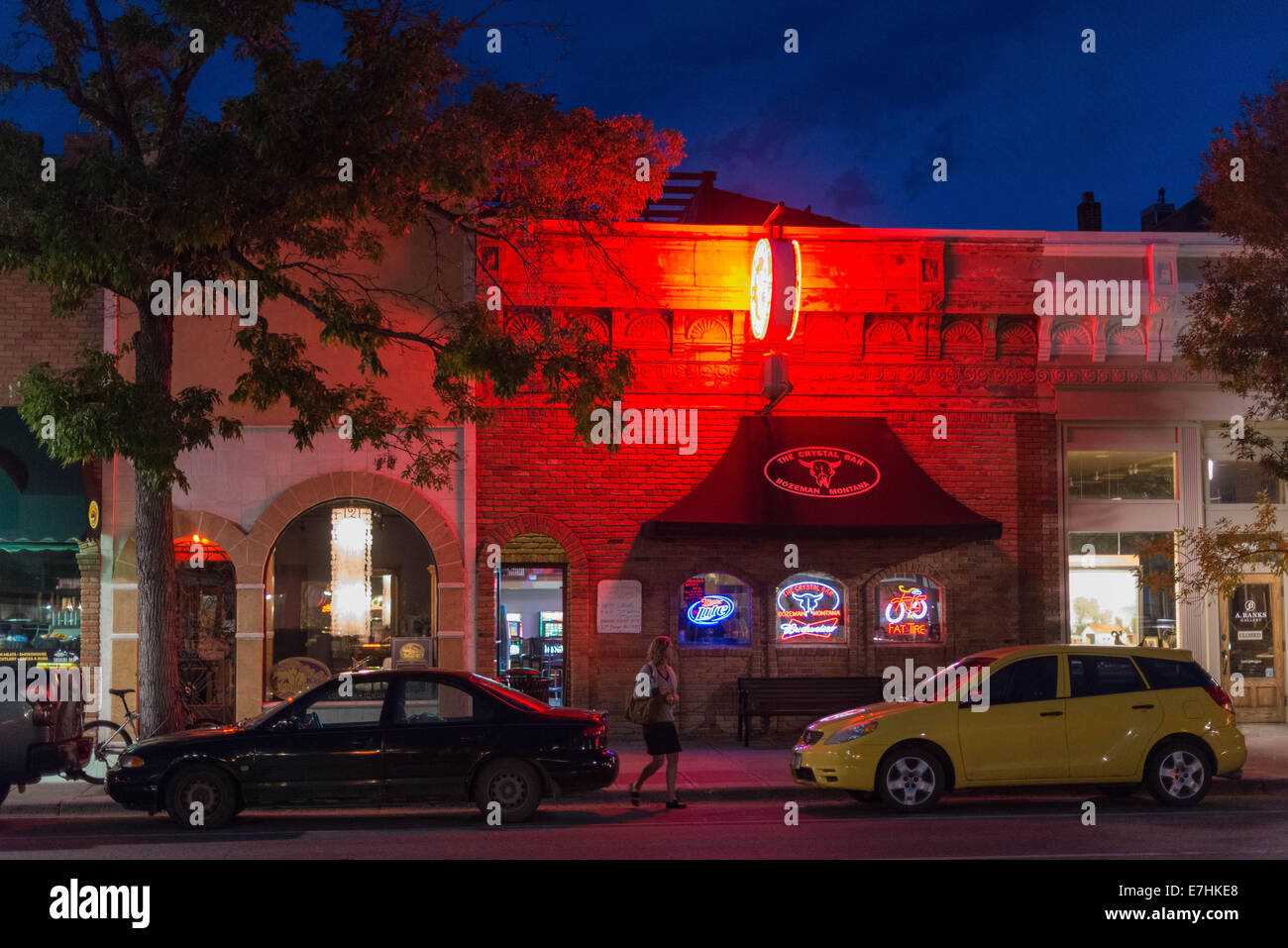 A woman walks toward her car as darkness descends Wednesday evening, 17th Sept., 2014, in downtown Bozeman, Mont., USA. As the autumnal equinox approaches, days in the northern latitudes are getting remarkably shorter. Stock Photo