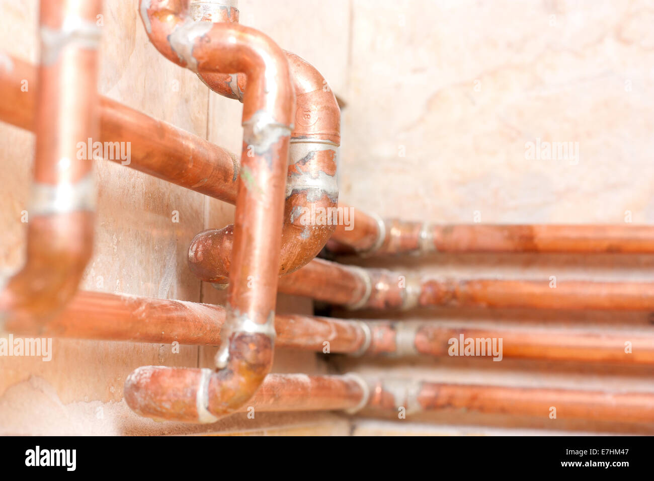 Different copper pipes on the wall Stock Photo Alamy