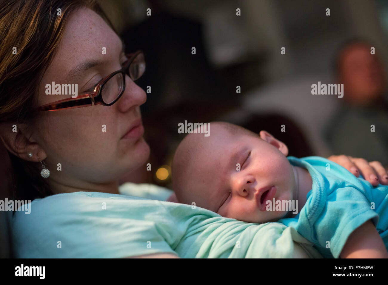 Denver, Colorado - A two-month-old baby sleeps, held by his mother. Stock Photo