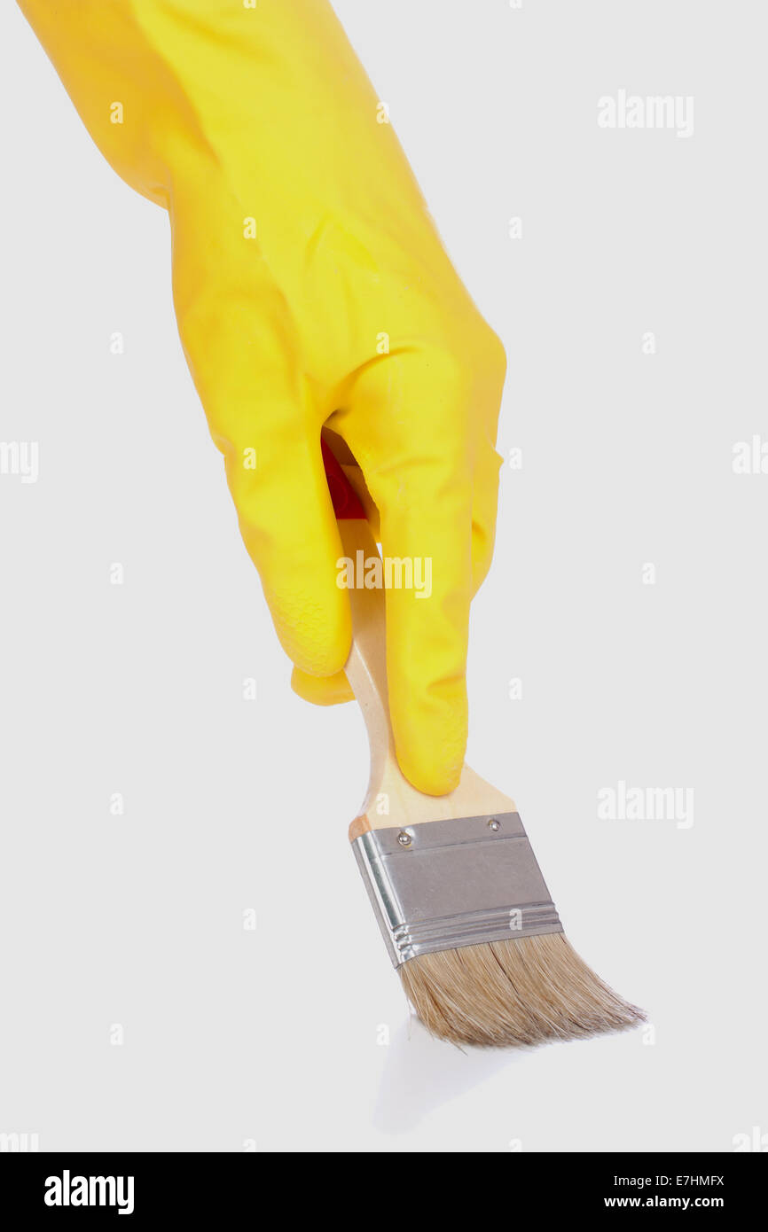 Hand in glove with brush isolated over white background Stock Photo