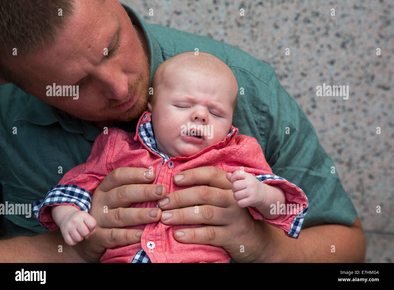 Denver, Colorado - Adam Hjermstad Sr. holds his two-month-old son, Adam Hjermstad Jr. Stock Photo