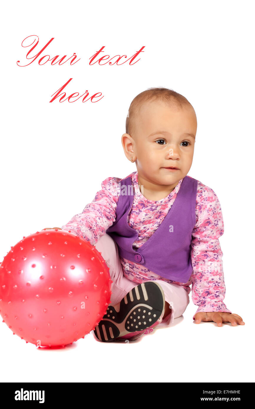 Baby girl playing with bright red ball in studio isolated on white background Stock Photo