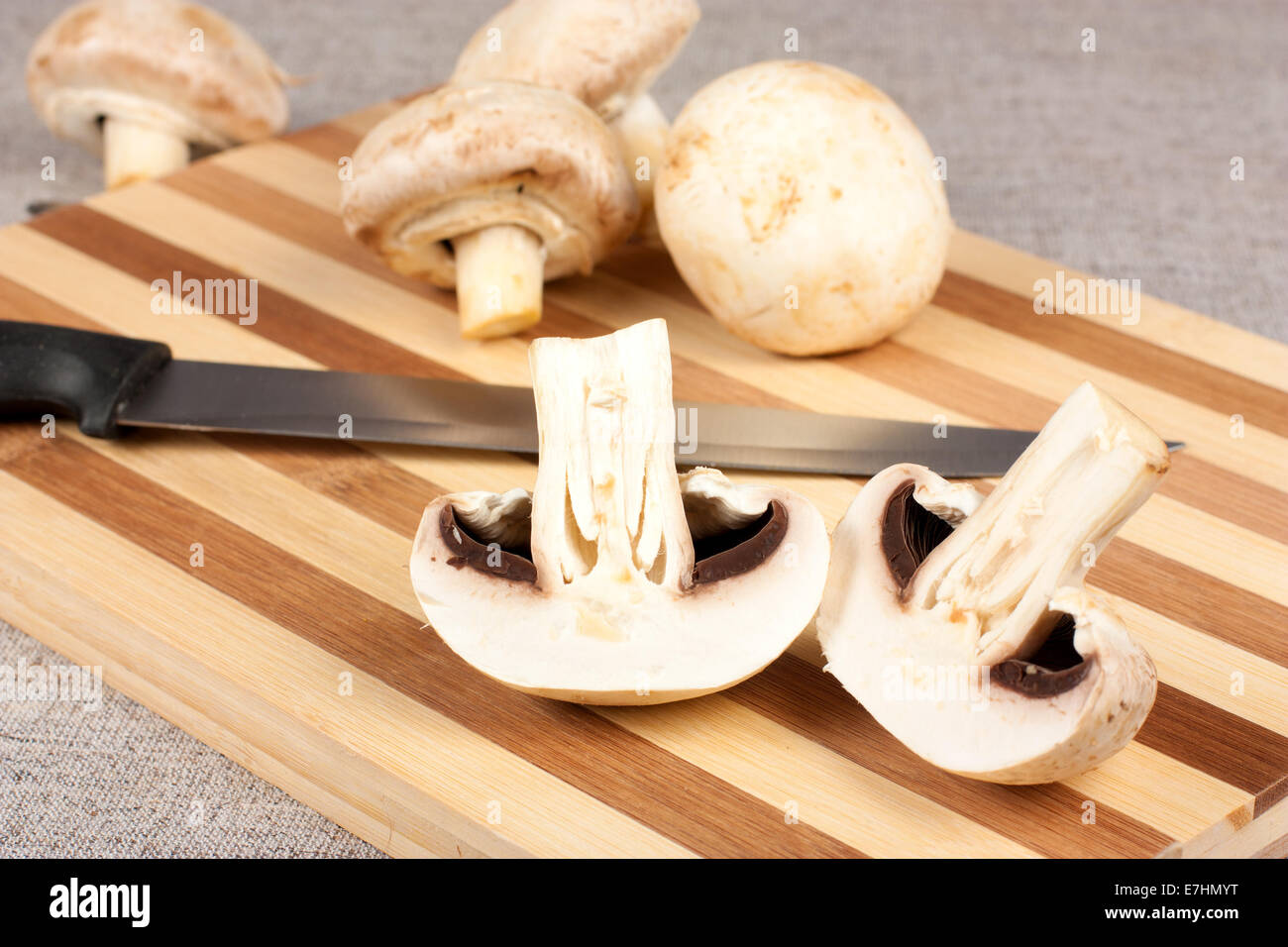 Mushrooms on a cutting board with a knife on a cutting board Stock Photo