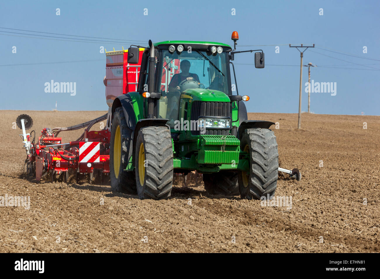 John Deere tractor sowing seeds on a field, wheat, seasonal work, Czech Republic farmer Stock Photo